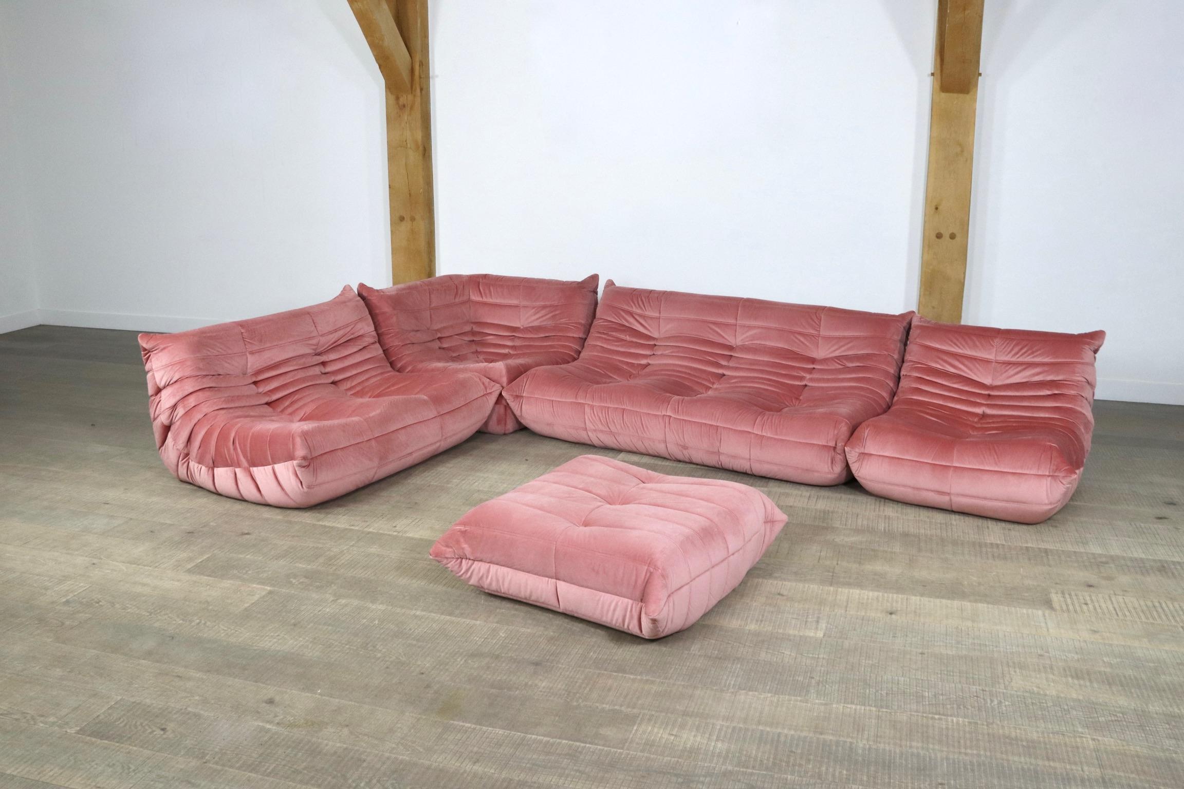 Beautiful pink velvet Togo seating group by Michel Ducaroy for Ligne Roset, 1970s. The entire seating group has the original Ligne Roset logo. The set consists of a 3-seater, a 2-seater, a corner, a lounge chair and ottoman. The beautiful fabric and