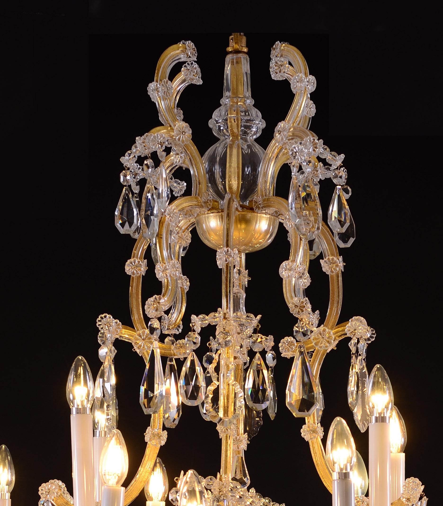 Very large Maria Theresa chandelier with 28 candles material metal frame with baluster decoration in the center, richly decorated with glass prism
This chandlier is in perfect condition and suitable for the US 
 