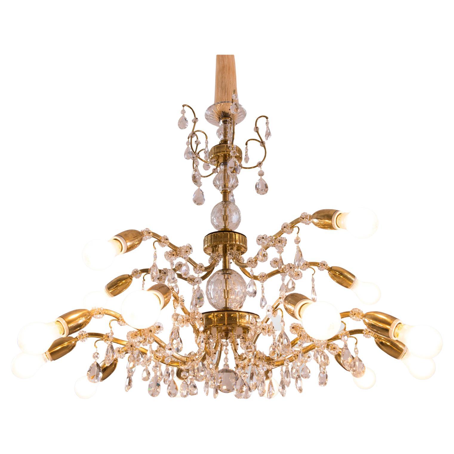A very rich decorated Austrian, 1960s chandelier, tremendous handcraft with chased parts and handblown column and hand-cut crystal glass, 15 flames. The height is just the chandelier

Suitable for the US market.
 