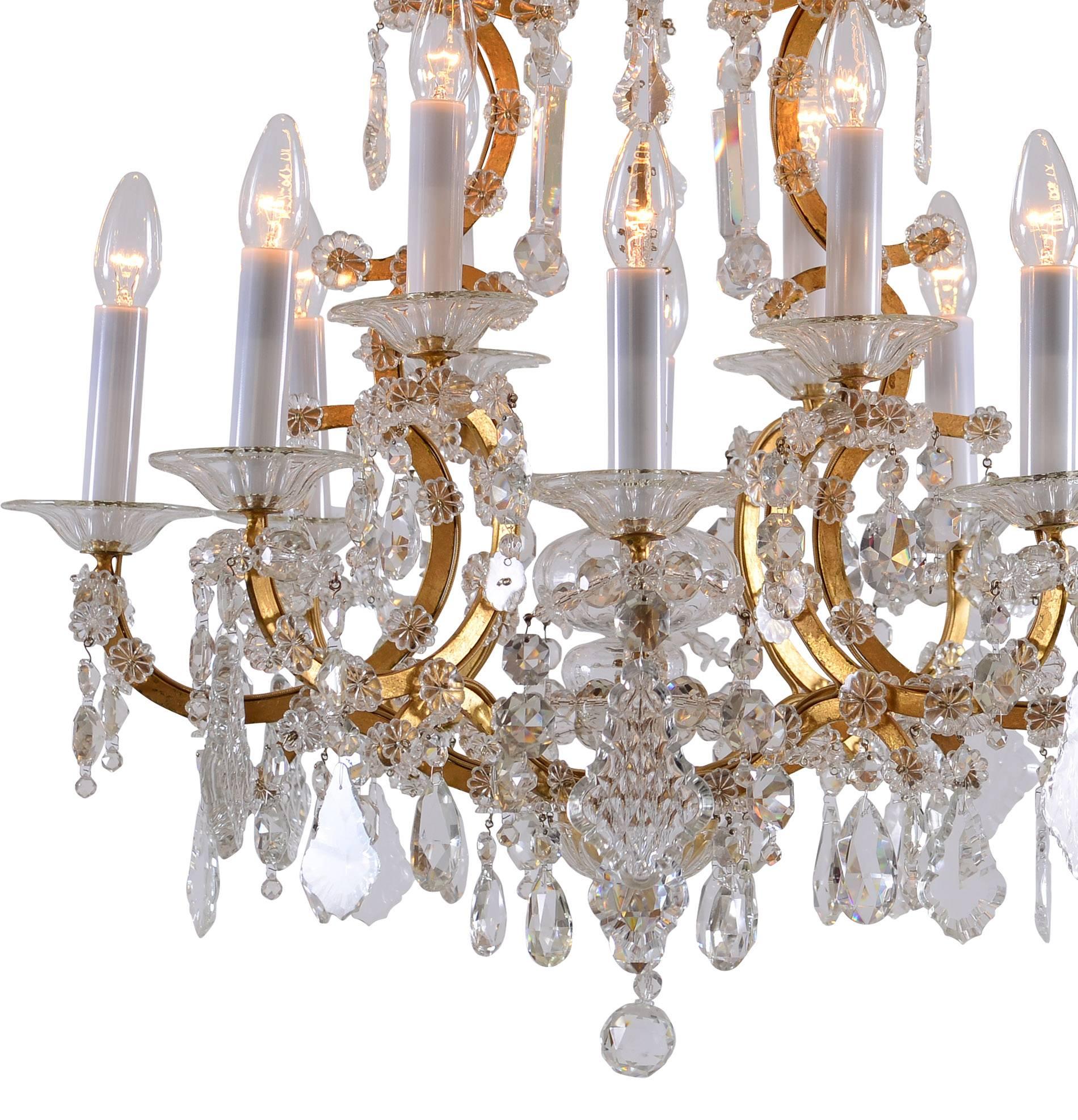 Very elegant glass-chandelier 
Material
forged iron gilded, crystal-glass.