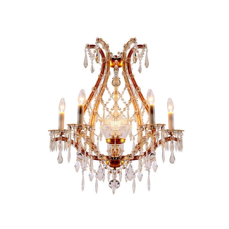 Very elegant glass-chandelier with rich hanging.
Material used is forged iron gilded, crystal-glass. 

 All components according to the UL regulations.