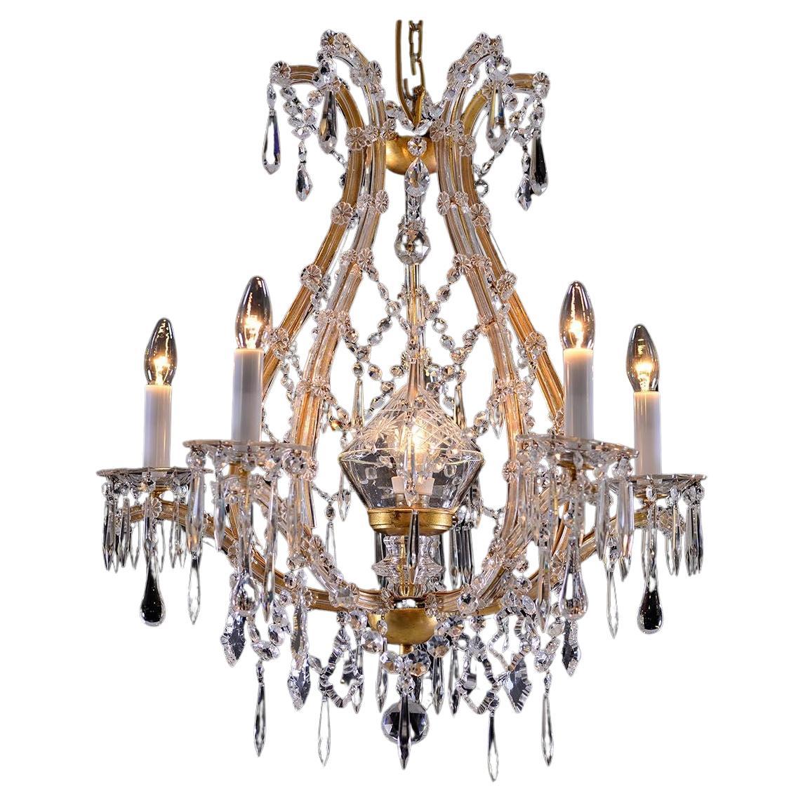 Very elegant glass-chandelier with rich hanging.
Material used is forged iron gilded, crystal-glass. 

 All components according to the UL regulations.