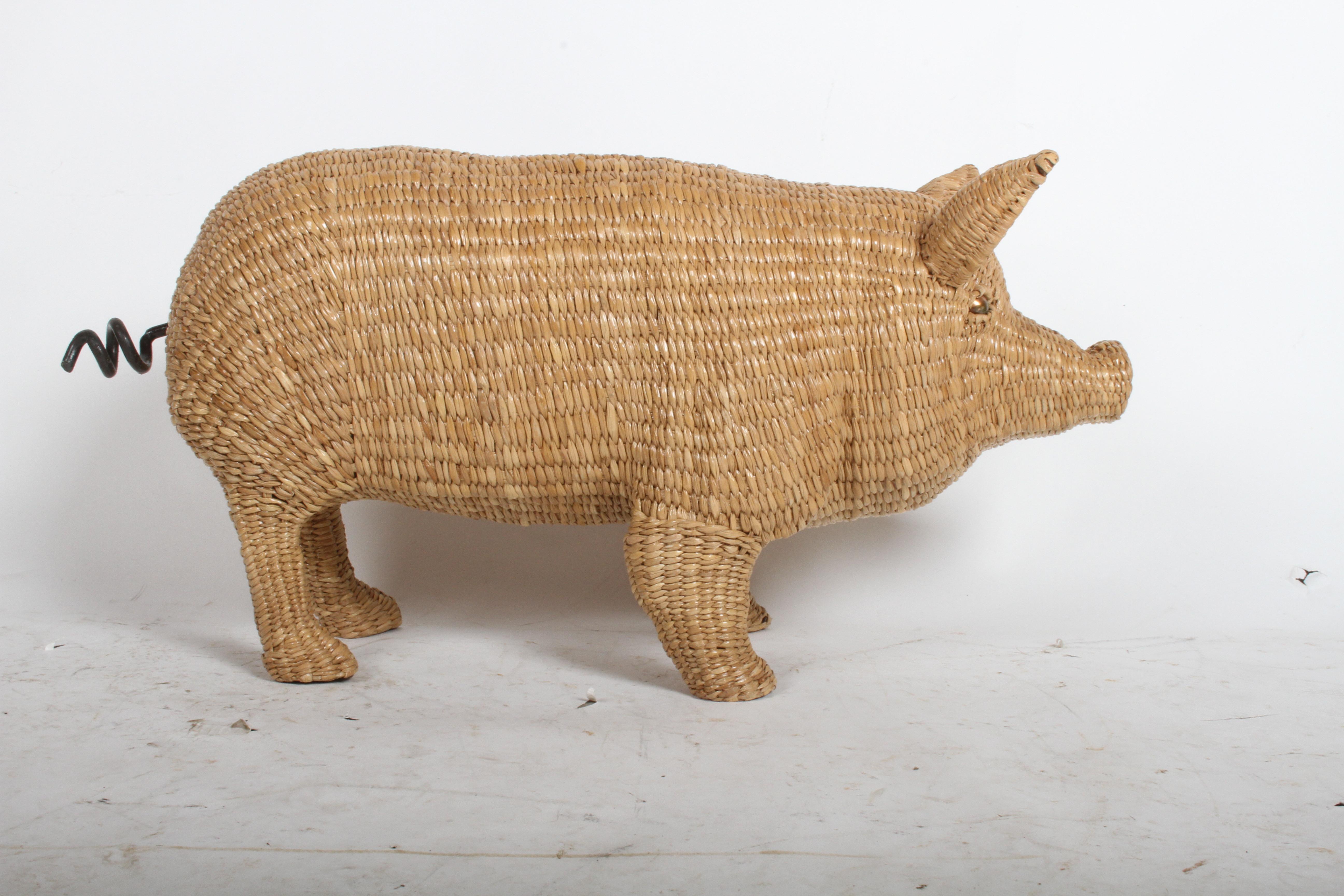 Rarely seen and highly sought after Mario Lopez Torres wicker pig sculpture. Wicker woven over iron frame, copper eyes and iron tail. Signed and dated on a brass medallion found on the underside chest of the pig: Mario Lopez Torres, Tzumindi, Hecho