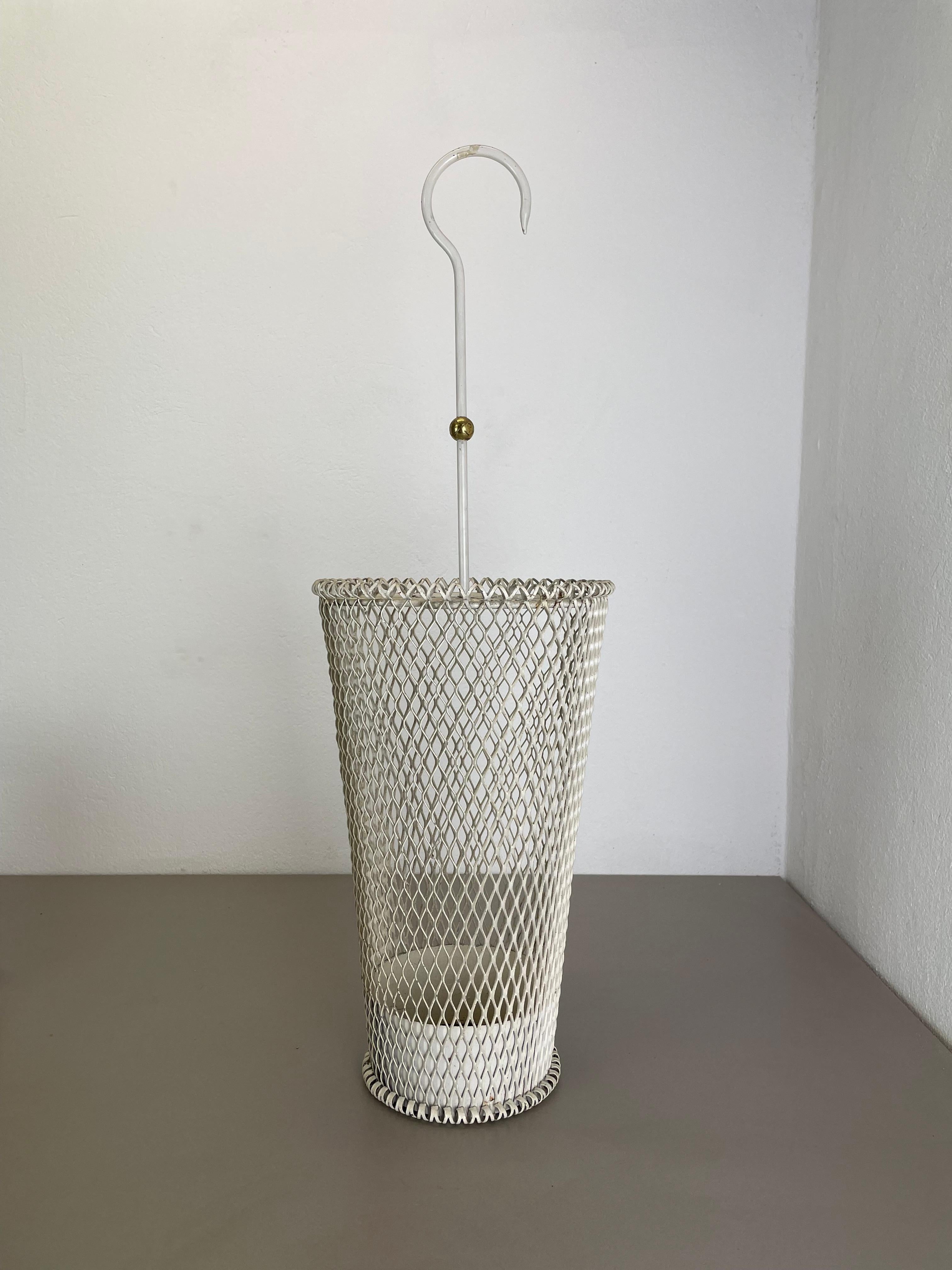 Article:

Umbrella stand in style of Matégot



Origin:

France


Age:

1950s





This original vintage umbrella stand was produced in the 1950s in France. It is made of solid metal in white lacquered tone. At the top this umbrella stand has a