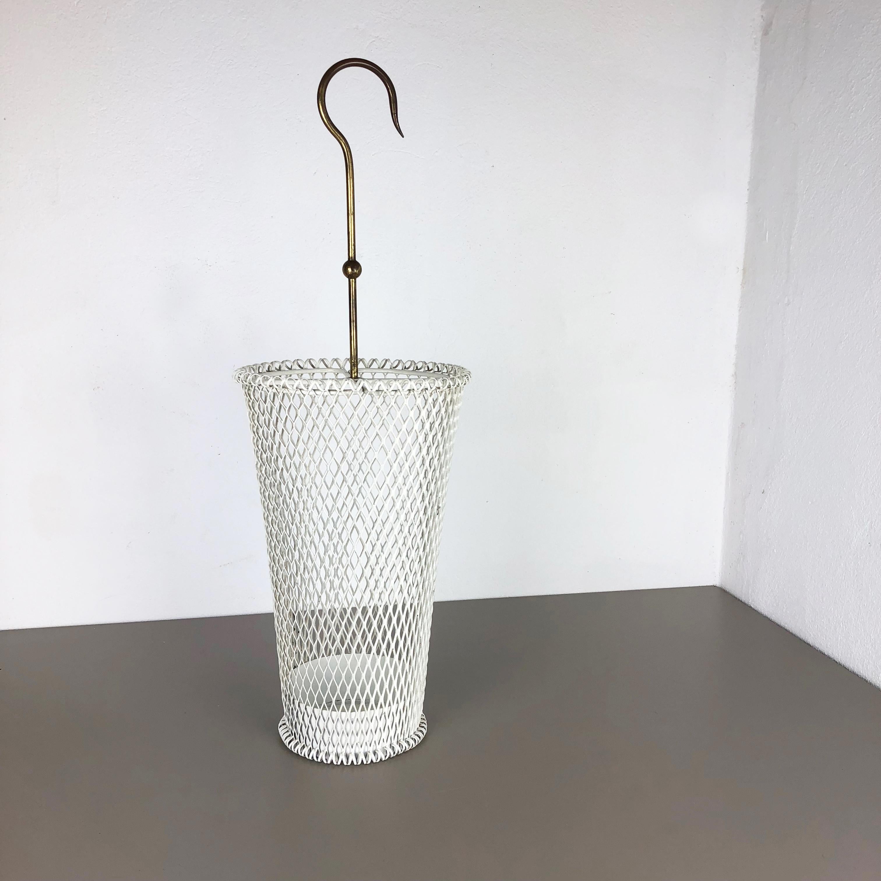 Article:

Umbrella stand in style of Matégot



Origin:

France


Age:

1950s





This original vintage umbrella stand was produced in the 1950s in France. It is made of solid metal in white lacquered tone. At the top this