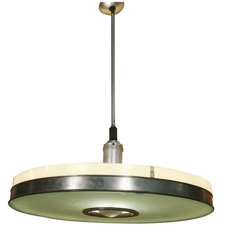 This streamlined aluminum ceiling lamp pair features an original frosted glass shade embellished with a polished aluminum neck. The piece hangs at 34 inches and can be shortened to the desired height. 

The fixture originally made for the May