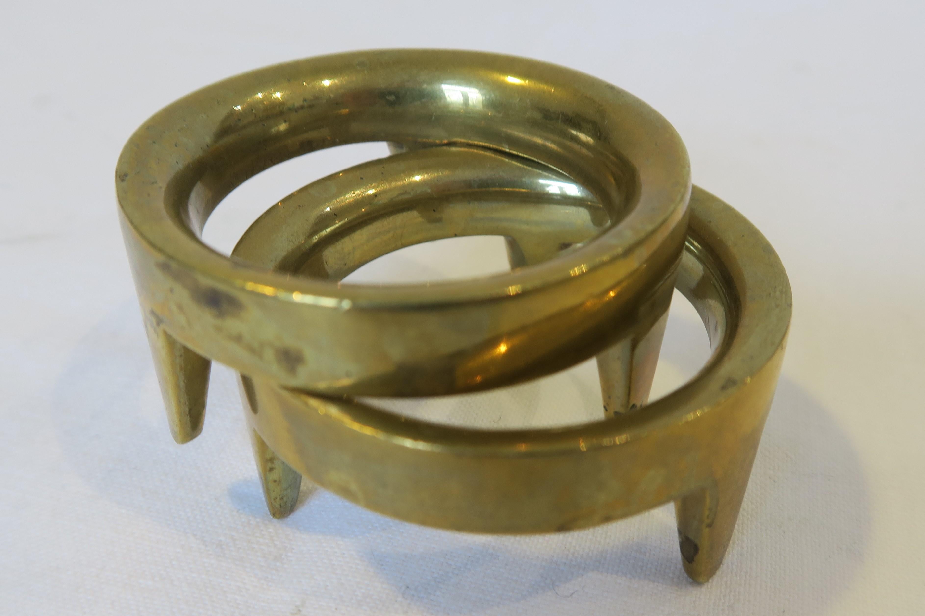 For sale is a beautiful set of two matching egg cups. Both were crafted from brass and designed by the renowned workshops of Carl Auböck in Austria. They consist of an elegant, slim band with three little pointy, rounded feet are examples of the