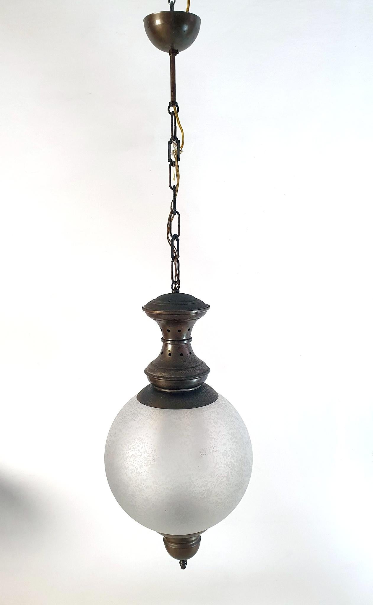 Italian Mid-Century Modern pendant lamp designed by Luigi Caccia Dominioni for Azucena during the 1950s.
The model is named LS1 and has frosted glass and bronzed iron metal details. We have purpously not restored this piece but rather left it in the