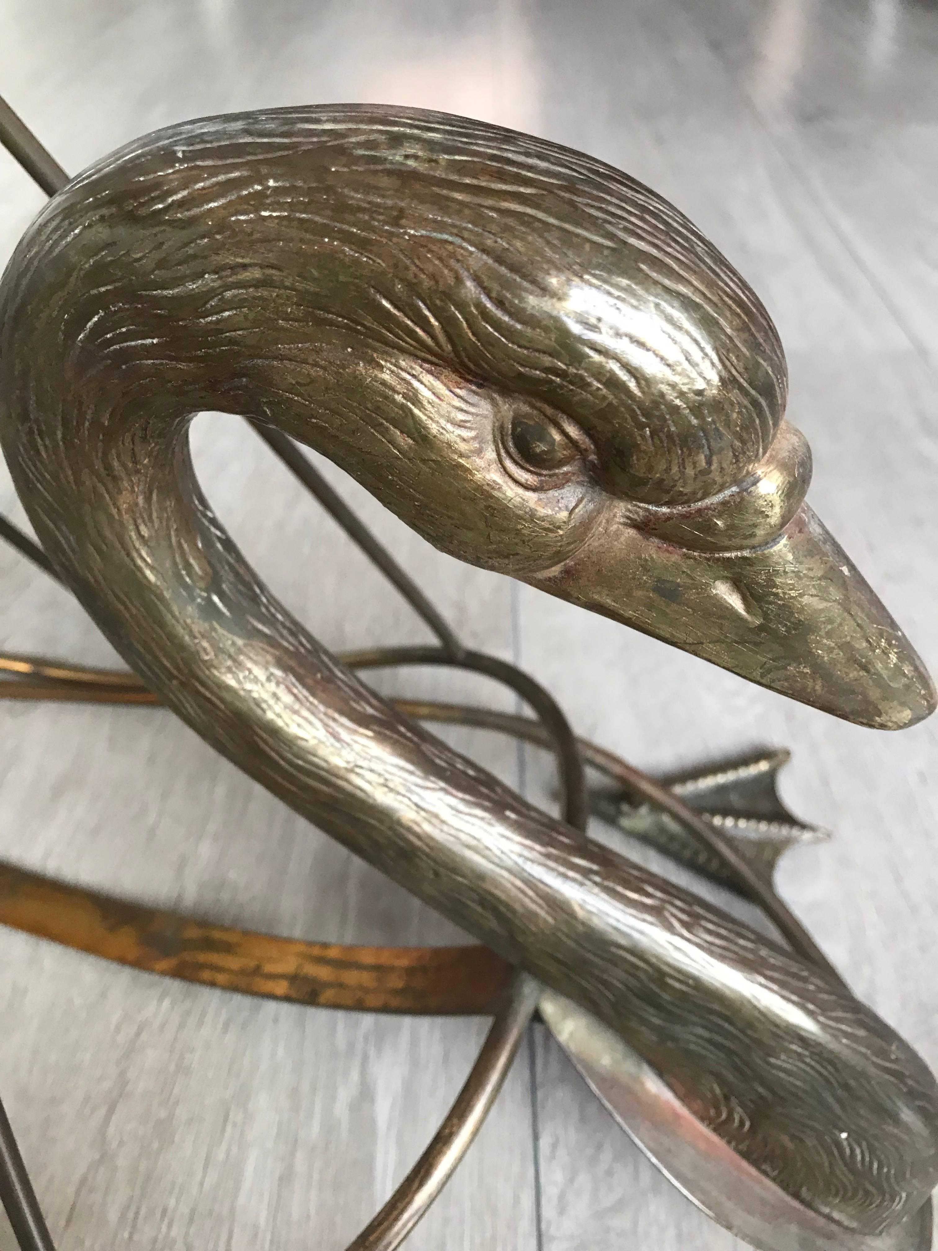 Wonderfully sculptural brass magazine stand attributed to Maison Jansen.

This practical size and highly decorative swan magazine rack is exactly what you would expect from the mid-century designers of Maison Jansen. Both the coolness of the design