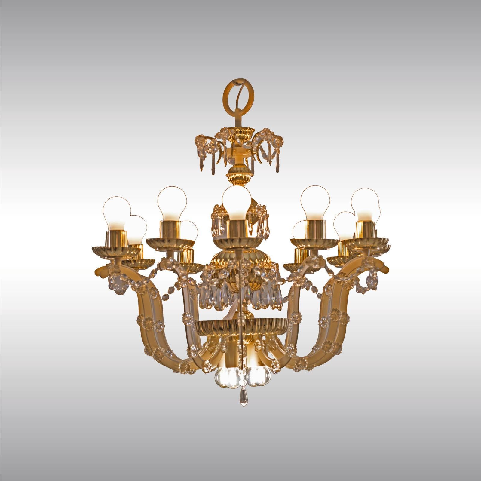 Magnificent chandelier from circa 1960, Mid-Century Modern, chased parts in brass and glass-application.
       