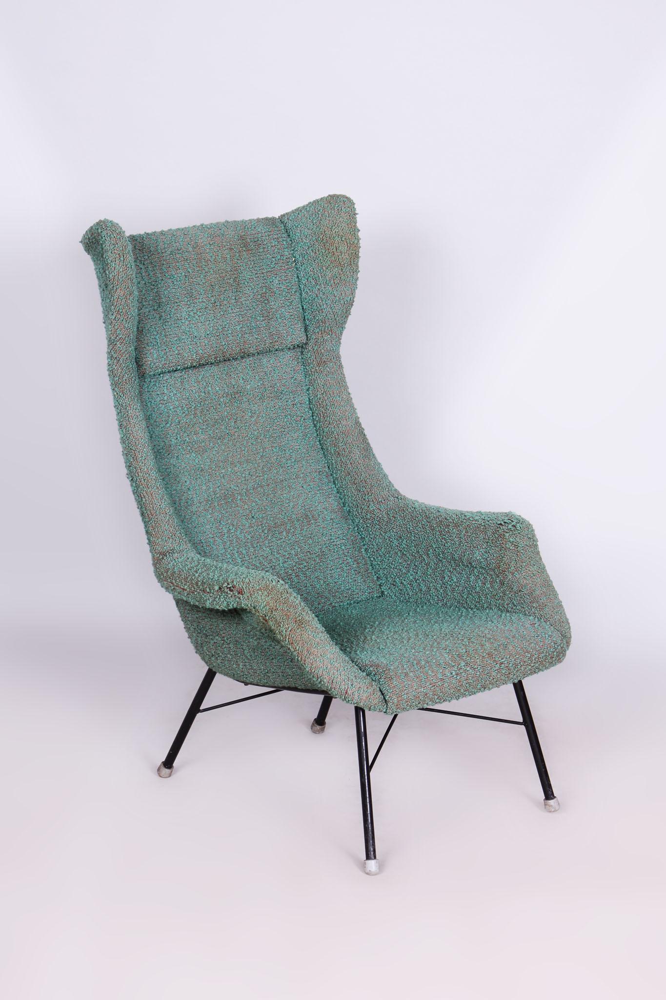 This iconic Wing Chair from the mid-20th century was designed by renowned Czechoslovak architect Miroslav Navrátil. Its sculpted fiberglass-reinforced plastic shell provides solid support and ergonomic comfort, while the original textile upholstery