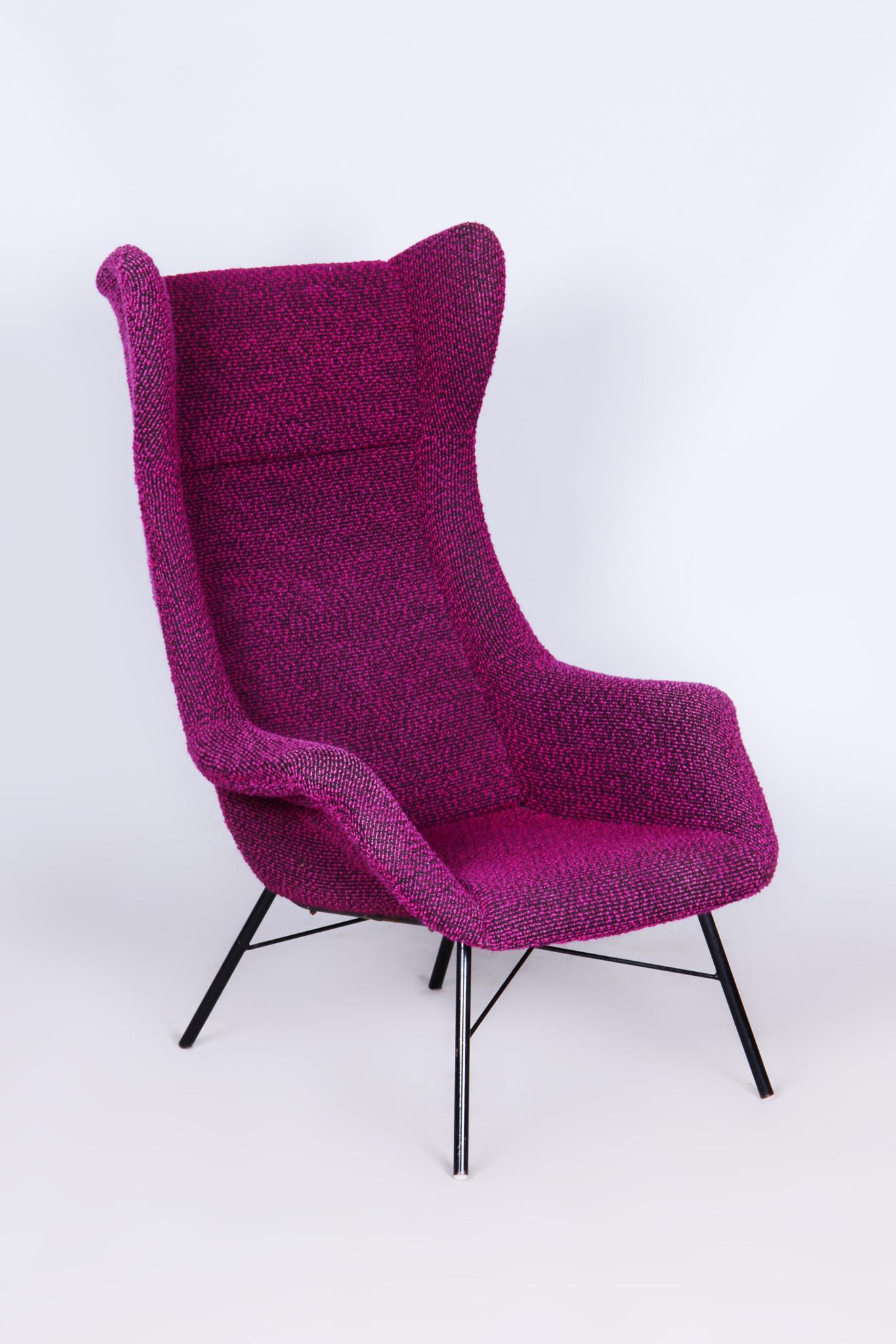 This iconic Wing Chair from the mid-20th century was designed by renowned Czechoslovak architect Miroslav Navrátil. Its sculpted fiberglass-reinforced plastic shell provides solid support and ergonomic comfort, while the original textile upholstery