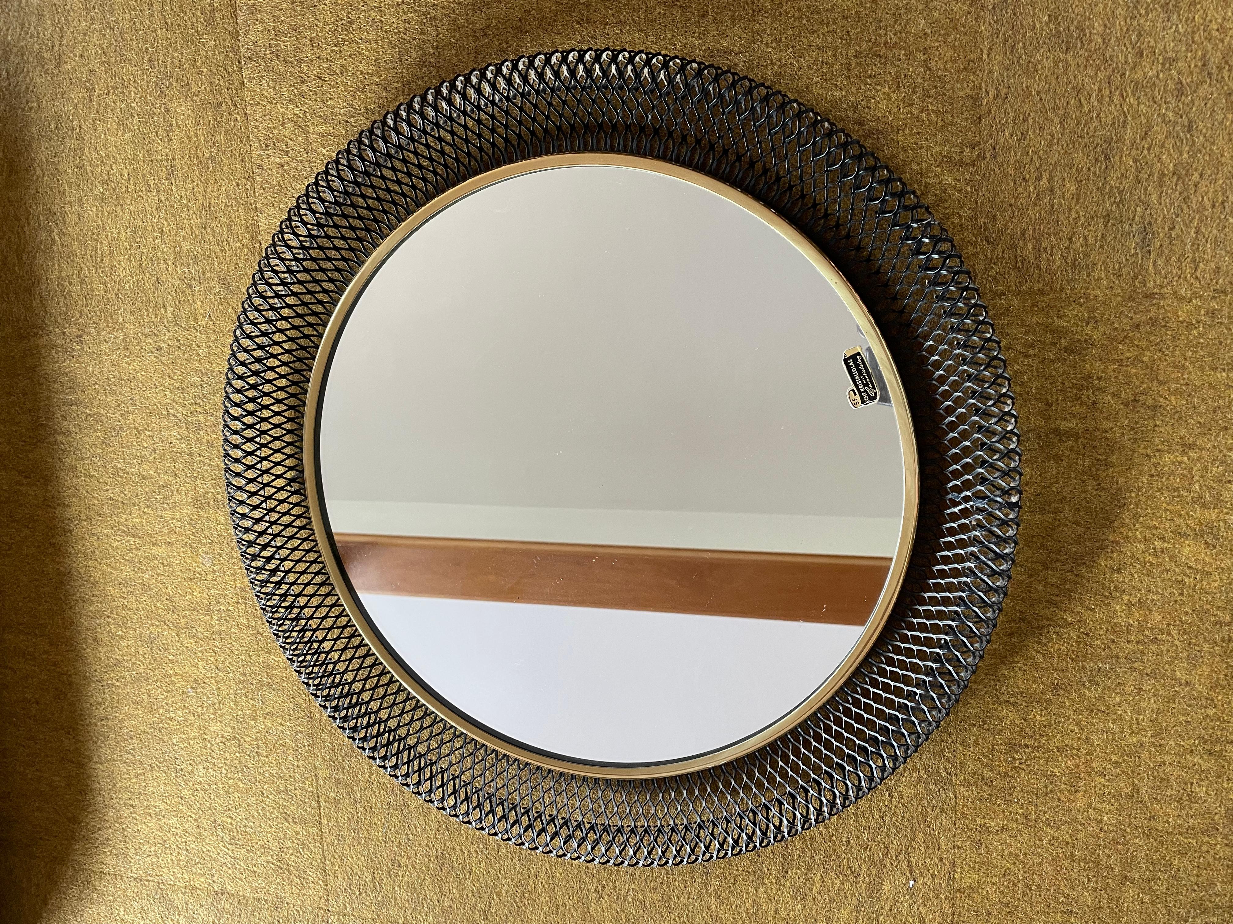 Article:

Wall mirror

Origin:

France

Design:

Remembers in design of Mategot

Age: 

1950s

This original vintage wall mirror was produced in the 1950s in France. it is made of solid metal with a metal grid perforation in black lacquered tone;