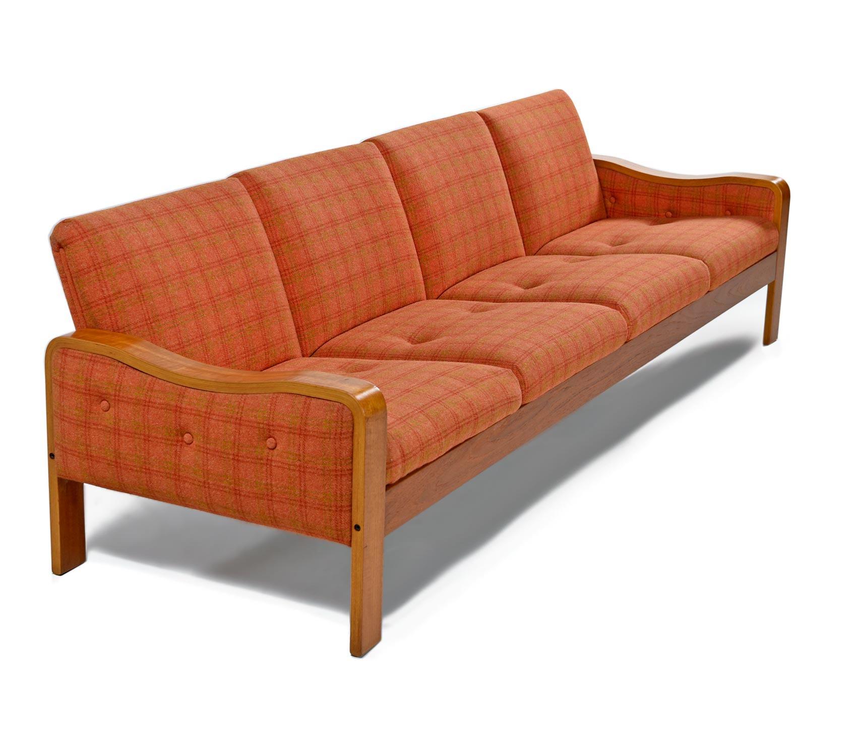 This sofa is in absolutely stunning original condition. A rare time capsule home treasure. We typically restore all of our upholstered finds, but this couch was in such outstanding condition that we decided to leave the original plaid wool fabric.