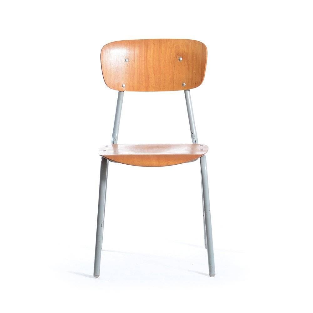 The original school chairs from Czechoslovakian schools offer wonderful Industrial feel and seating. These adult size chairs are made of grey metal construction and molded plywood seat and backrest. Some of the chairs have original school writing on