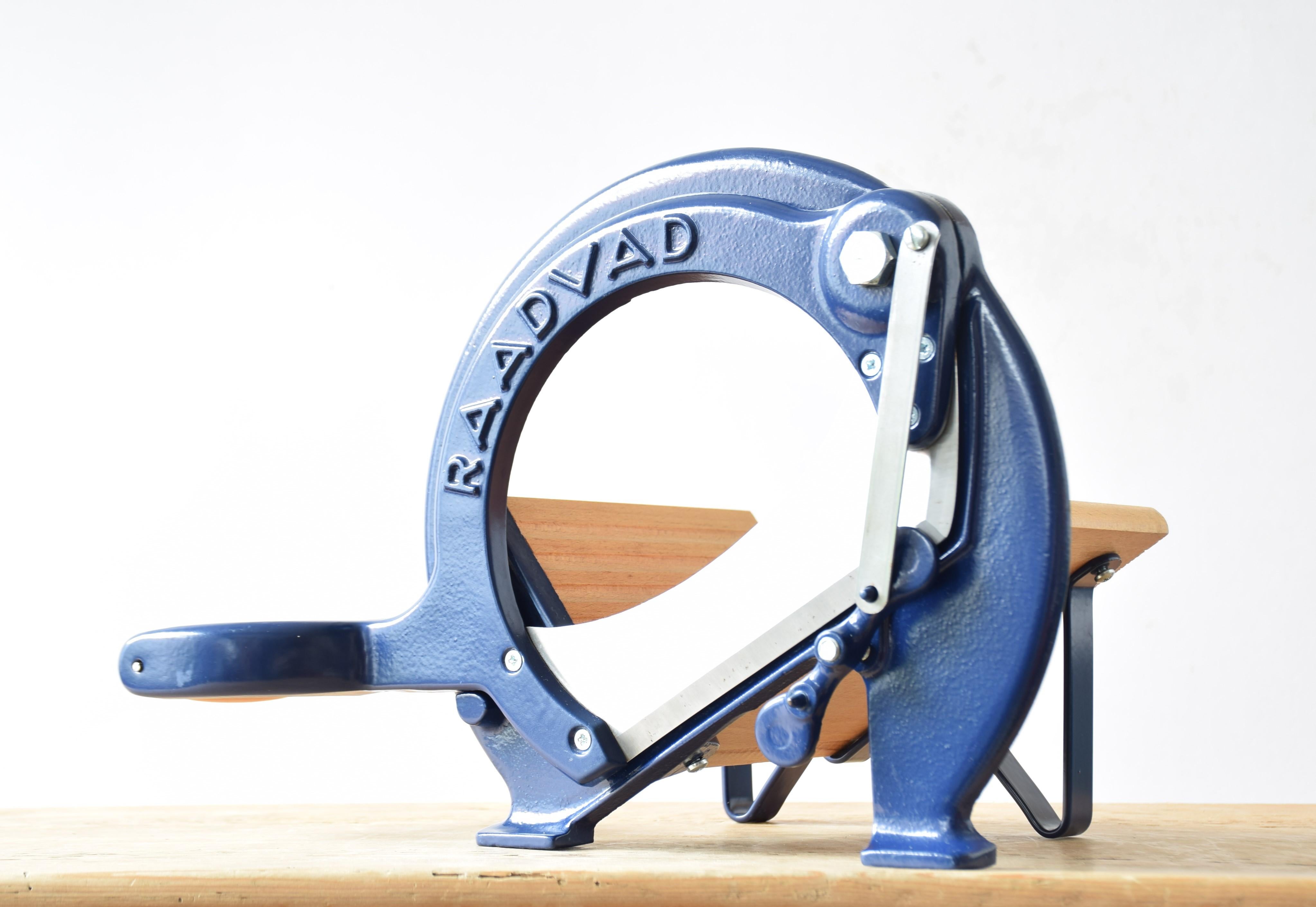 This iconic Danish bread slicer was produced by Raadvad in Denmark, circa 1970s-1990s. The color of the lacquer is the original dark blue. It´s very rare. It also came in a slightly more pale blue. The bread slicer is fully functional for slicing
