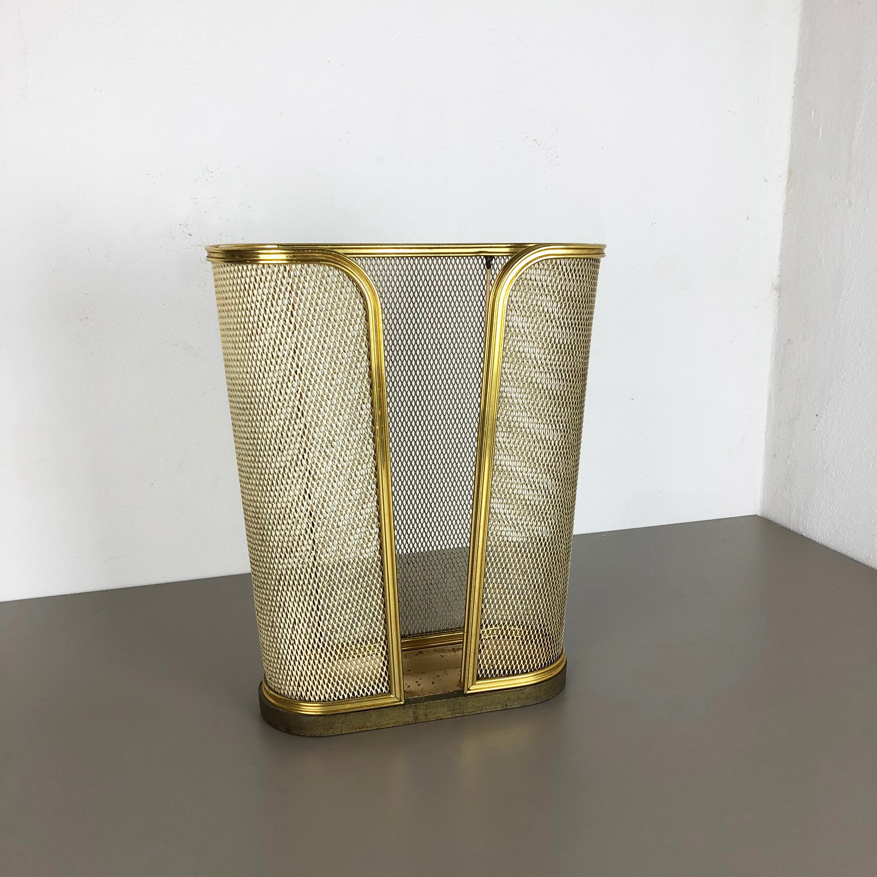 Article:

Bauhaus umbrella stand


Origin:

Germany


Age:

1950s


This original vintage Bauhaus style umbrella stand was produced in the 1950s in Germany. it is made of solid metal with brass applications at the top and bottom, and