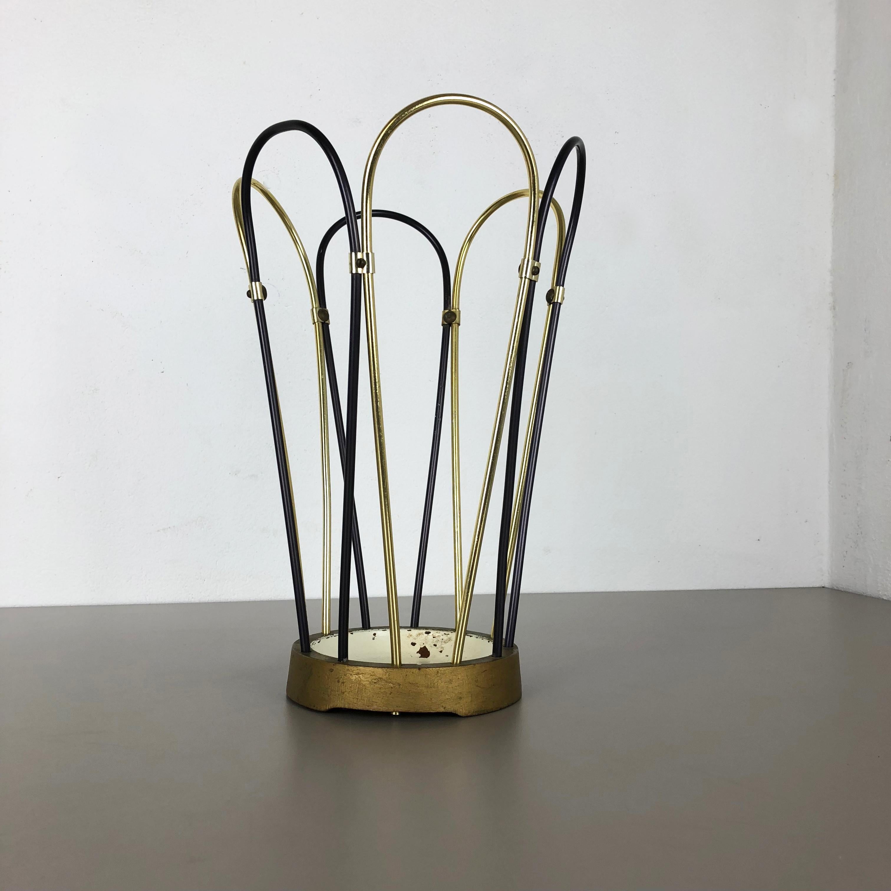 Article:

Bauhaus umbrella stand


Origin:

Germany


Age:

1950s


This original vintage Bauhaus style umbrella stand was produced in the 1950s in Germany. The brass colored top elements is made of aluminum, the black elements are