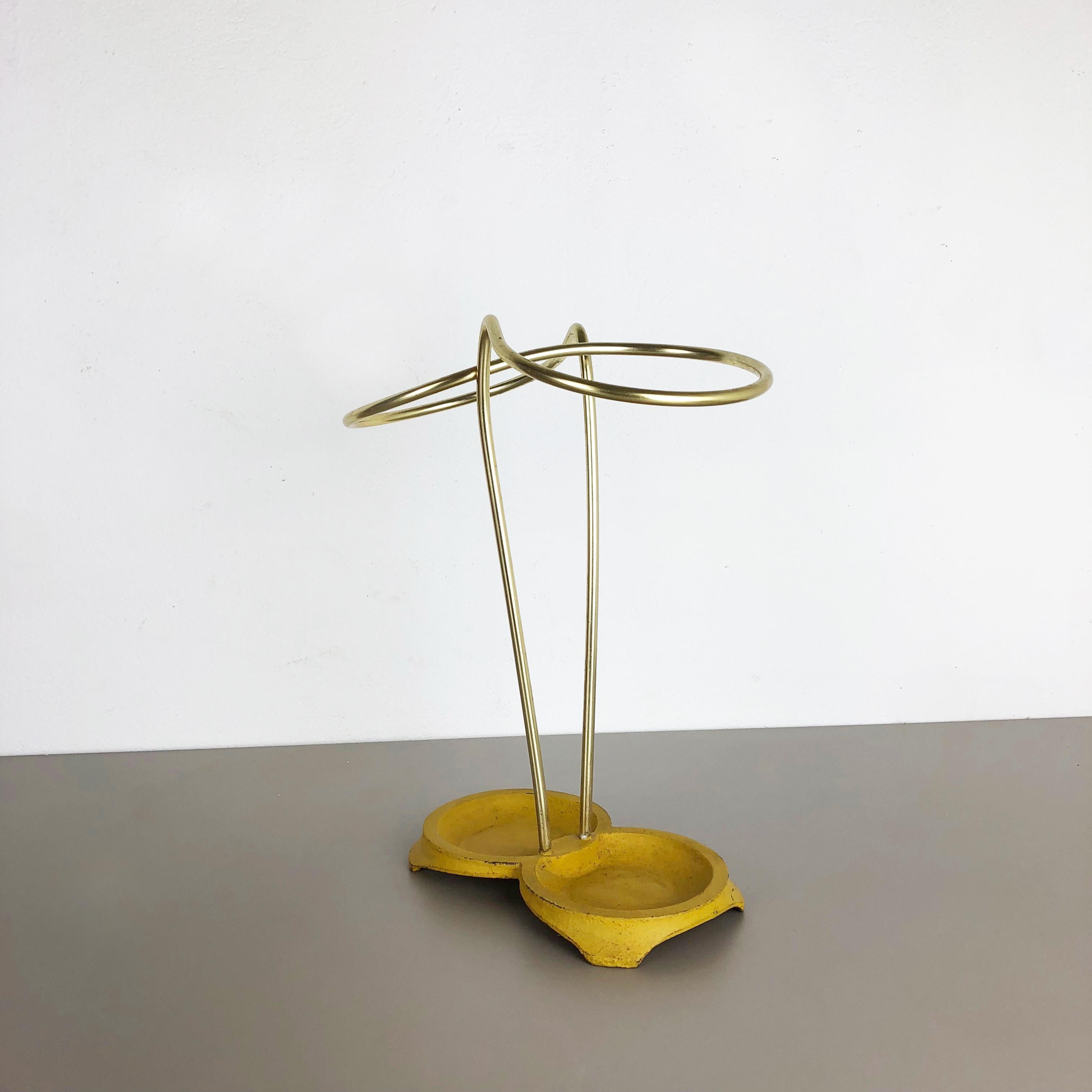 Article:

Bauhaus umbrella stand


Origin:

Germany


Age:

1950s


This original vintage Bauhaus style umbrella stand was produced in the 1950s in Germany. The brass colored top elements is made of aluminum, the heavy metal base