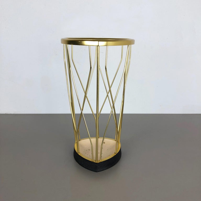 Article:

Bauhaus umbrella stand


Origin:

Germany


Age:

1950s


This original vintage Bauhaus style umbrella stand was produced in the 1950s in Germany. The brass colored top elements is made of aluminium, the heavy black metal
