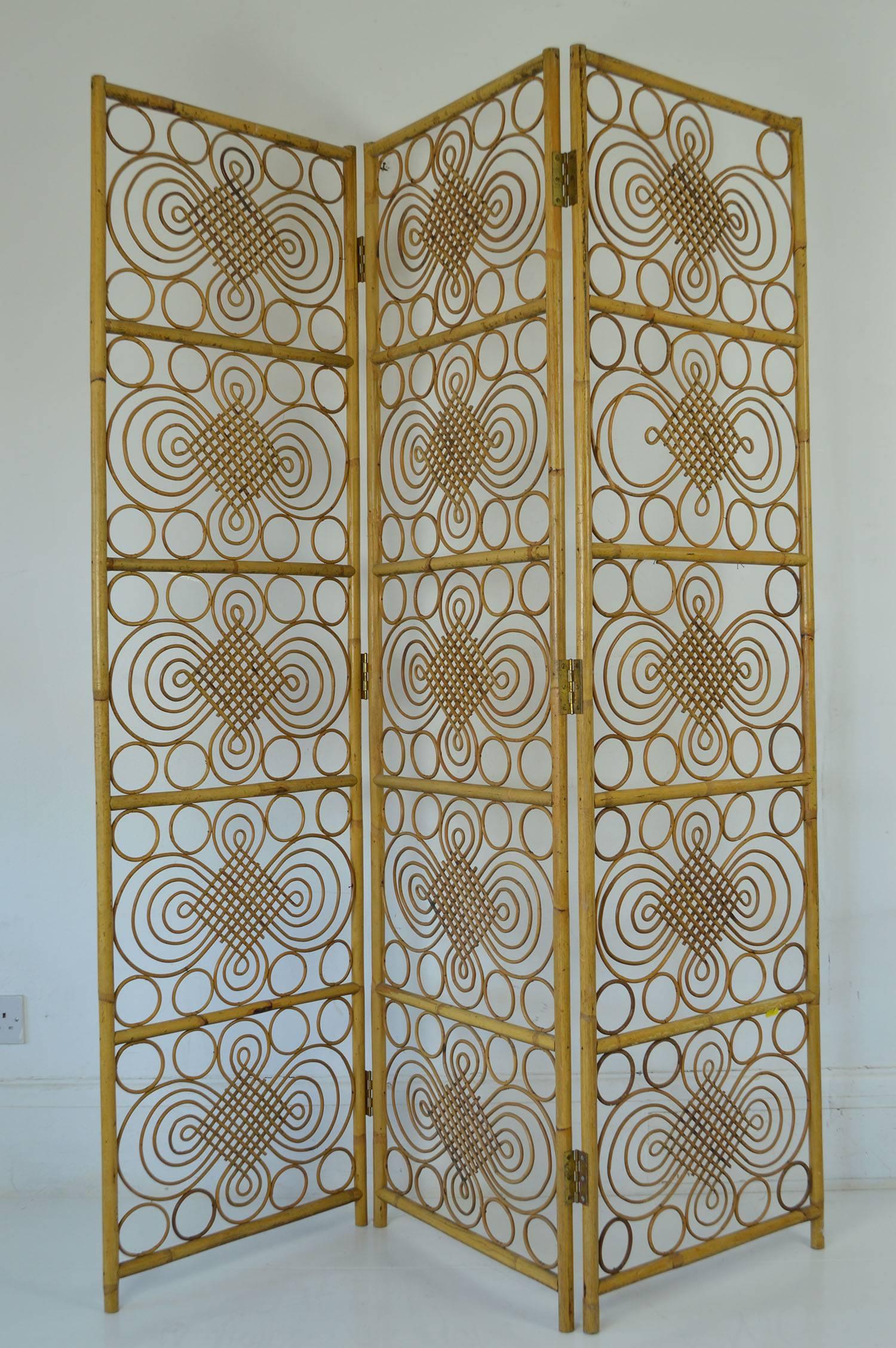 Great three-panel folding screen. Really good quality rattan work.

Very iconic 1960s look about it.

Designer and maker not known.

Stable when it is opened up.

Good quality brass hinges.

Two of the panels are in good condition. On one