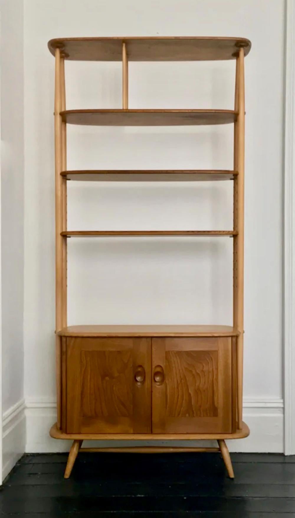 *** Please contact us for availability of this piece. ***

A tall free-standing room divider or bookcase, designed by Lucian Ercolani for his company Ercol in the late 1950s. Made of solid elm with beech uprights, and traditionally crafted in