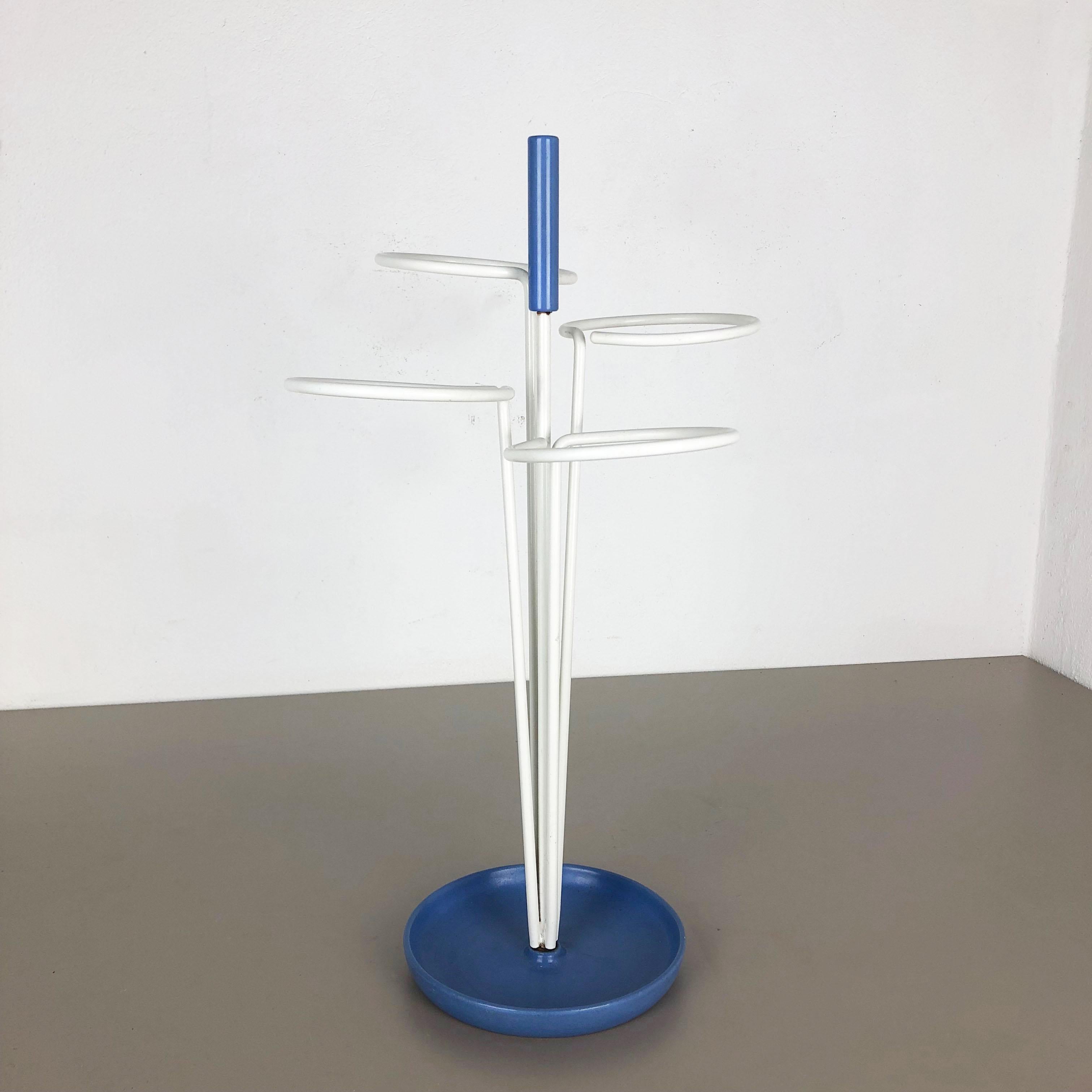 Article:

Umbrella stand


Origin:

Germany


Age:

1960s


This original vintage umbrella stand was produced in the 1960s in Germany. It is made of solid metal with white lacquered loop elements for umbrellas at the top and upright