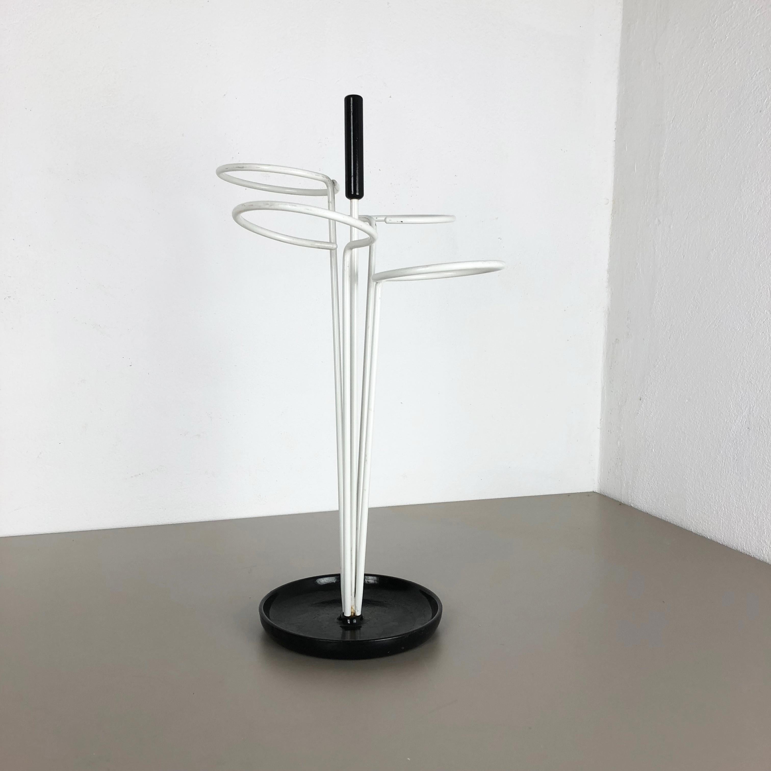 Article:

Umbrella stand


Origin:

Germany


Age:

1960s


This original vintage umbrella stand was produced in the 1960s in Germany. It is made of solid metal with white lacquered loop elements for umbrellas at the top and upright