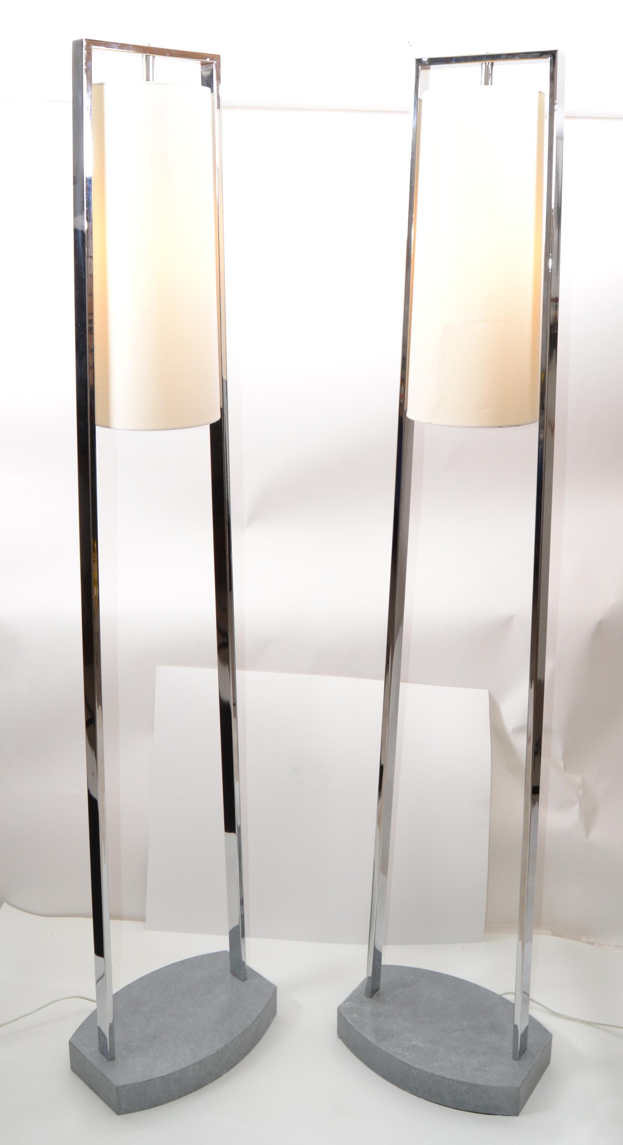A pair of tall modern Van Teal chrome floor lamps with cylindrical white linen hardback shades. Sturdy mounted on a faux green gray marbleized stone base.
In perfect working condition and each uses a large halogen bulb.
Note: No off / on