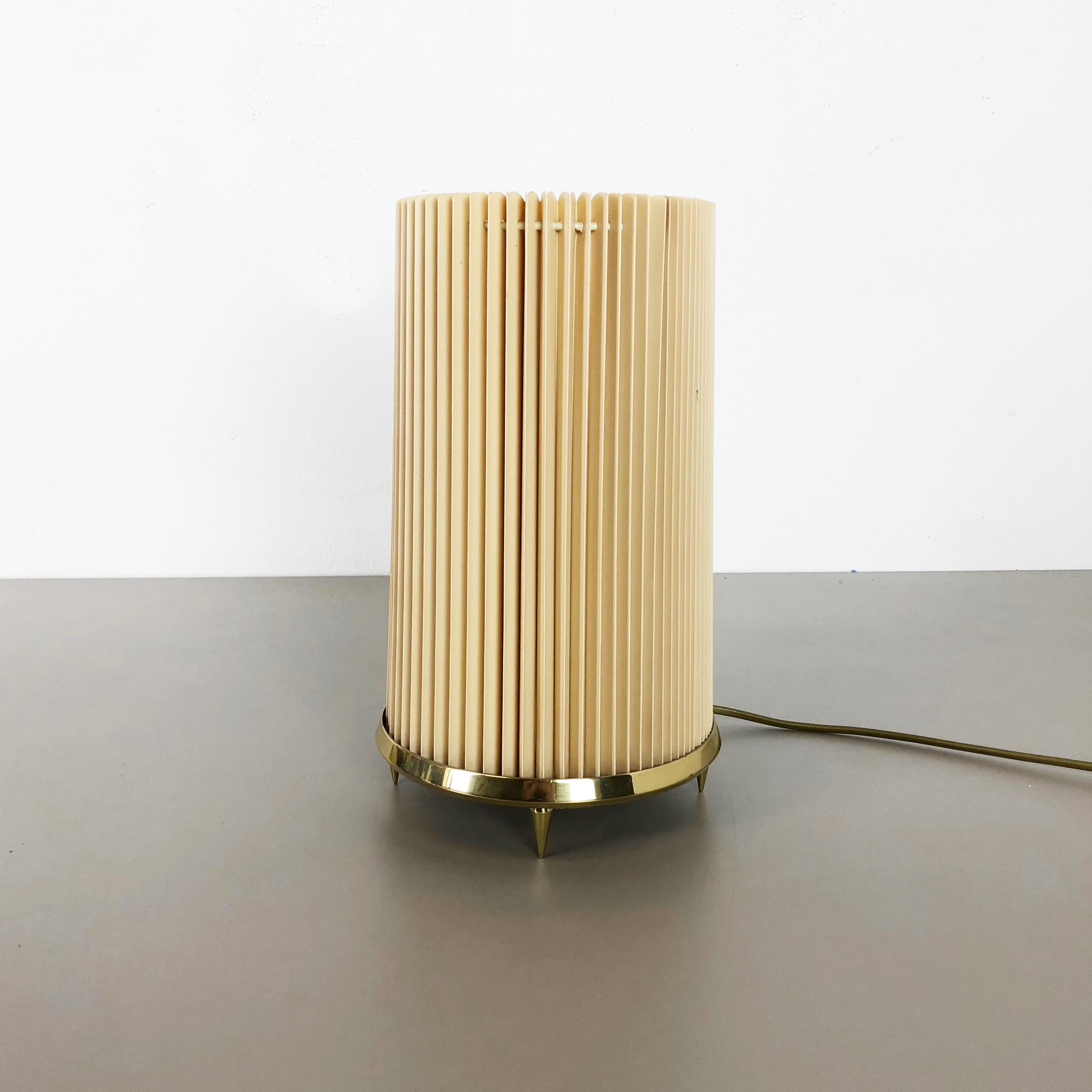 Article:

Table light


Origin:

Italy


Age:

1970s


Original 1970s table light made in Italy. This wonderful modernist 1970s table light comes with a huge original tube folded plissé plastic shade. The huge shade stands on a solid