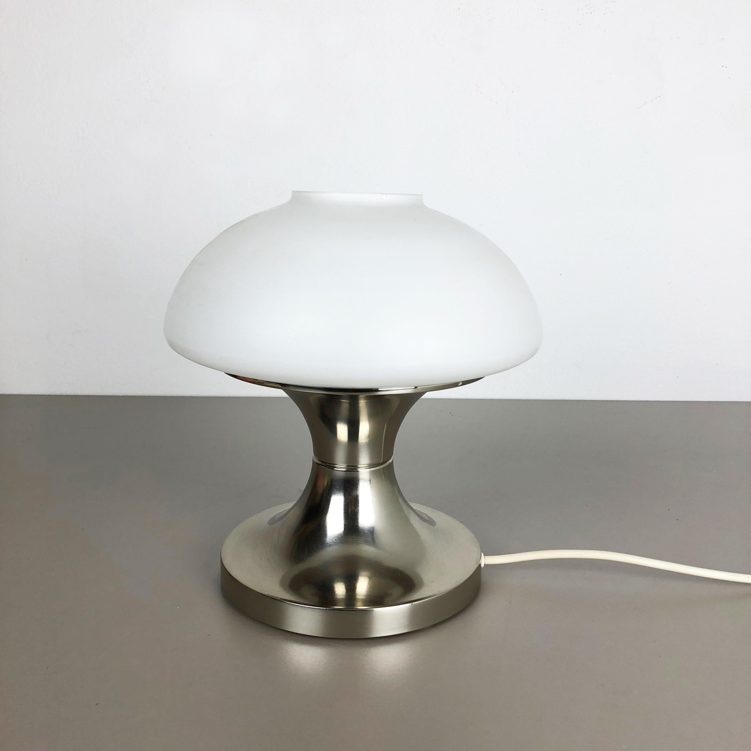 Article:

table light with opal shade


Origin:

Italy


Decade:

1970s





This original vintage light was designed and produced in the 1970s in Italy. it is made of metal and opal glass. The light has a metal base element in tulip form and at the