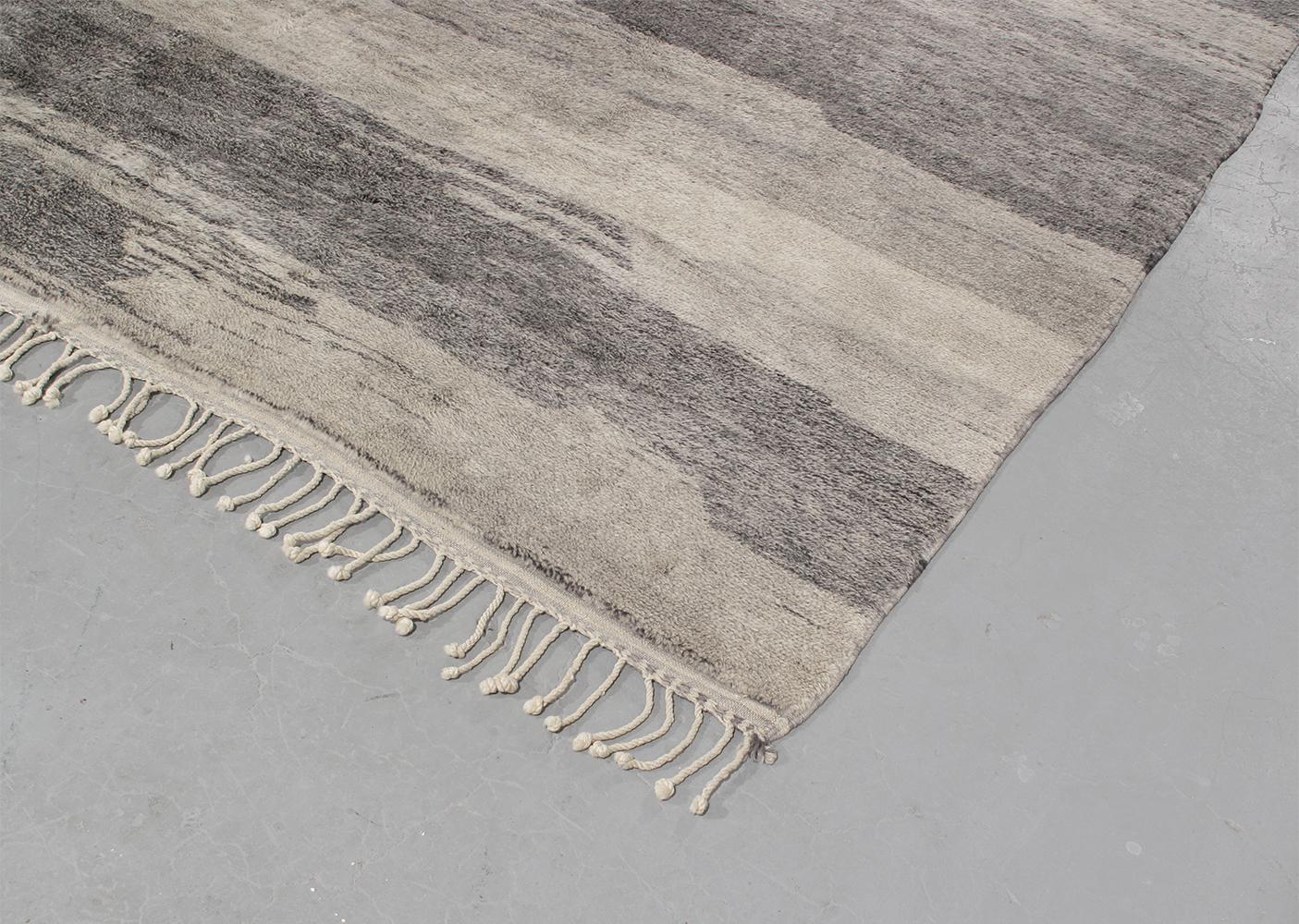 This original Moroccan rug is styled after the Beni Ourain rugs that were produced by the nomadic Berber tribes in North Africa for centuries. Beni Ourain rugs are identified by their geometric lines that form an overall asymmetrical pattern. NASIRI