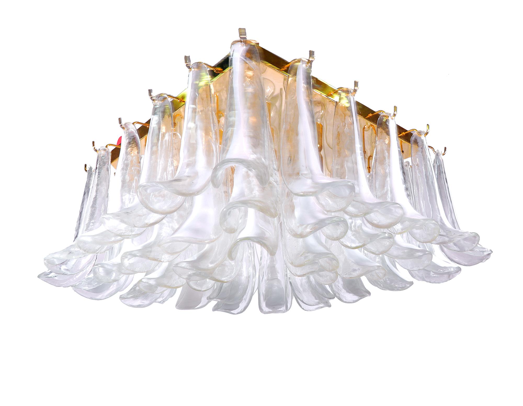 Elegant large square Murano glass flush mount petal chandelier. The color of the 52 glass petals goes from white to clear and fixed on a gilded brass frame. Some petals are branded, as imaged. Manufactured by Mazzaga, Italy in the 1970s. 

Design: