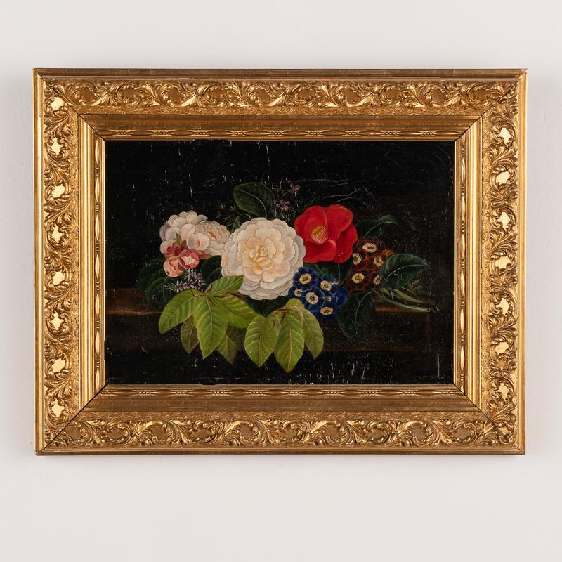 This delightful floral painting showcases vibrant colors of white, blue and red. Unsigned oil on canvas, I.L. Jensen's school, 19th Century. Arrangement with variety of flowers and beech leaves resting on stone table top. Canvas shows age related