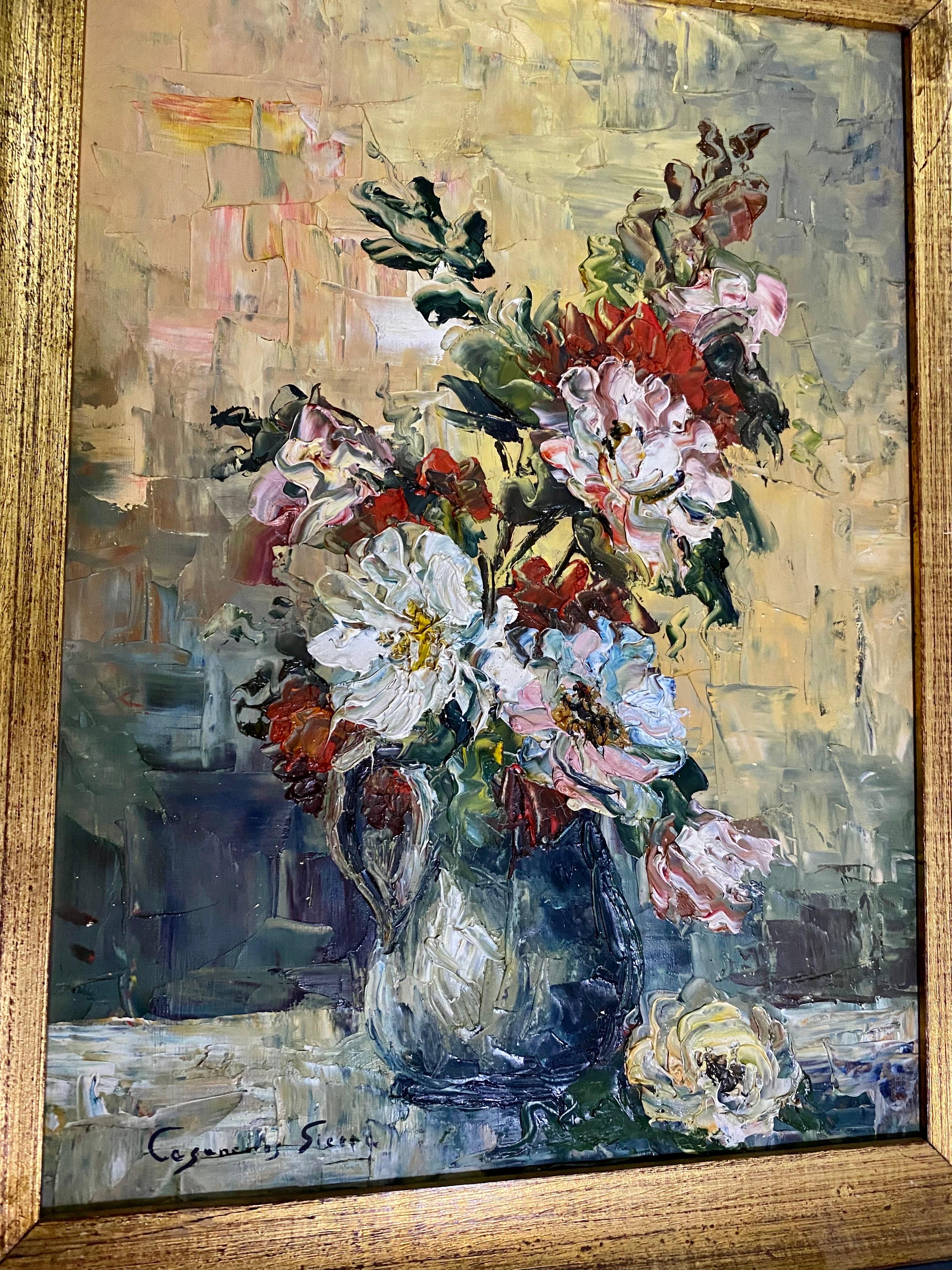 This Spanish still life knife oil painting captures a scene of a large bouquet of ancient rose flowers?  purple, pink, white j'hece and Bordeaux in a green tinted glass jug.  It is lying on a fabric, the bouquet is very harmonious, a graceful