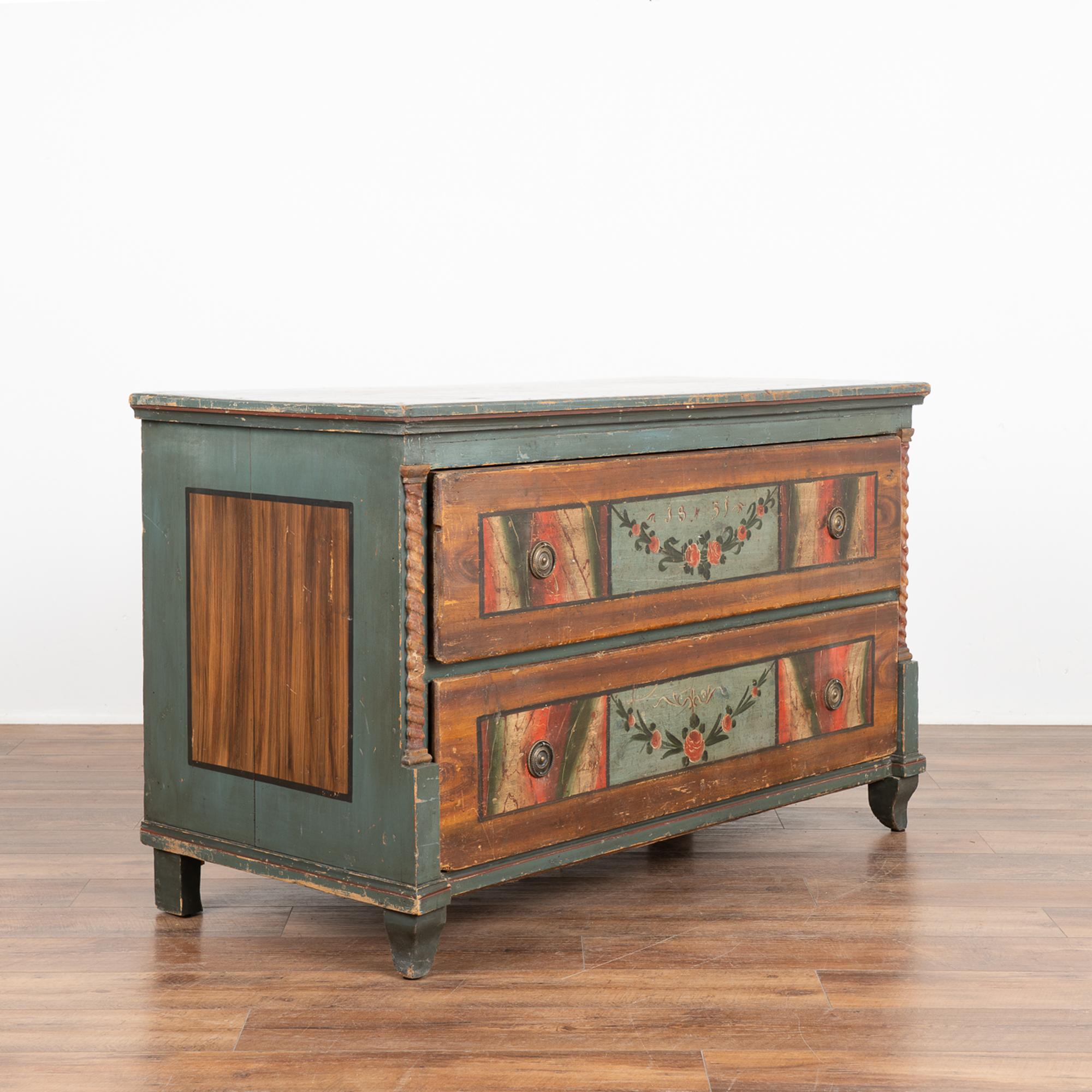 The vibrant colors are all original on this large painted chest of two drawers or 