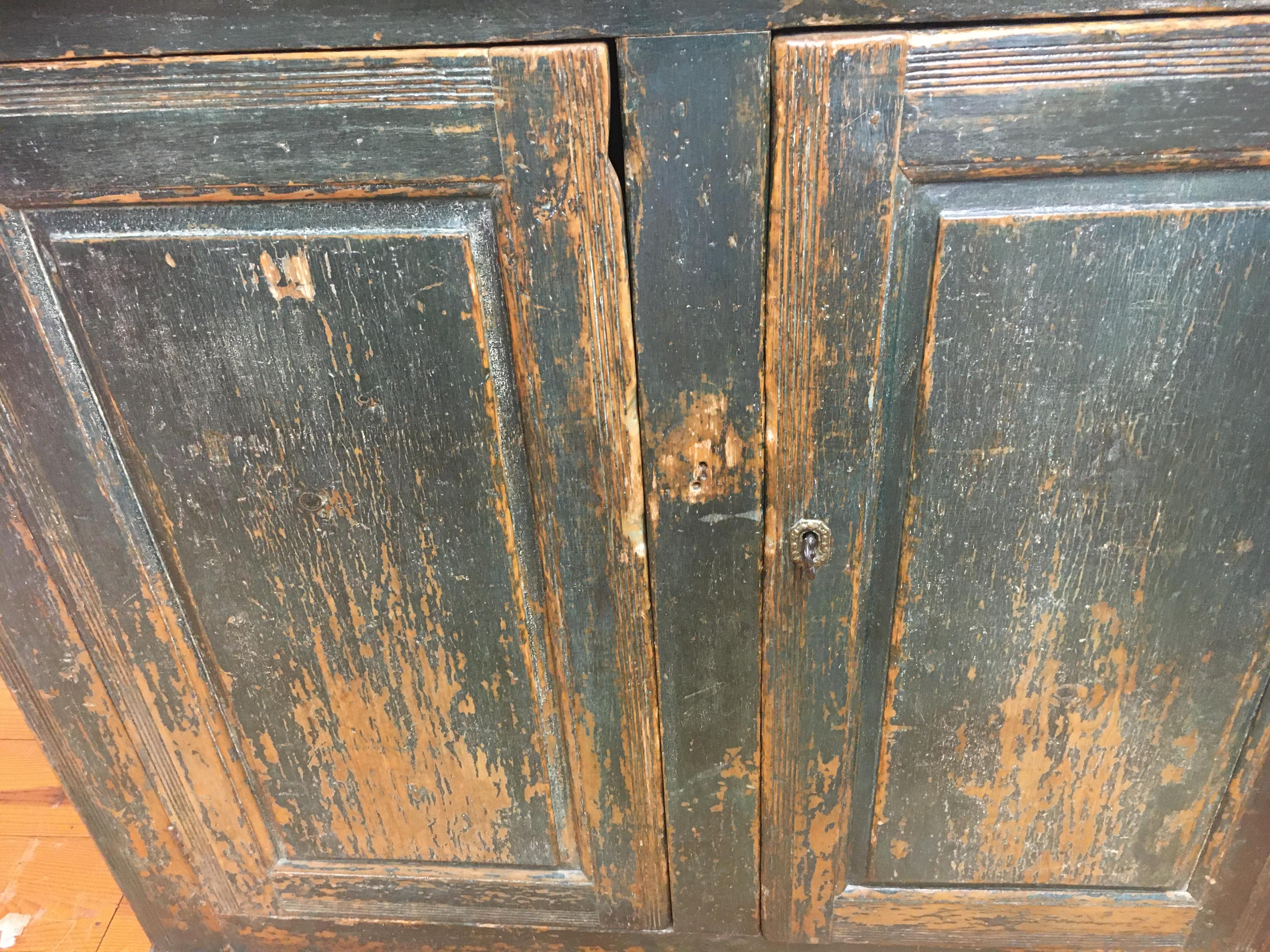 Pine, circa 1800, the best original painted large buffet we have found in the last 3 years. Blue or green in color and appropriately worn. This piece has raised panels and its original shelves inside for plenty of storage. Canadian furniture doesn't
