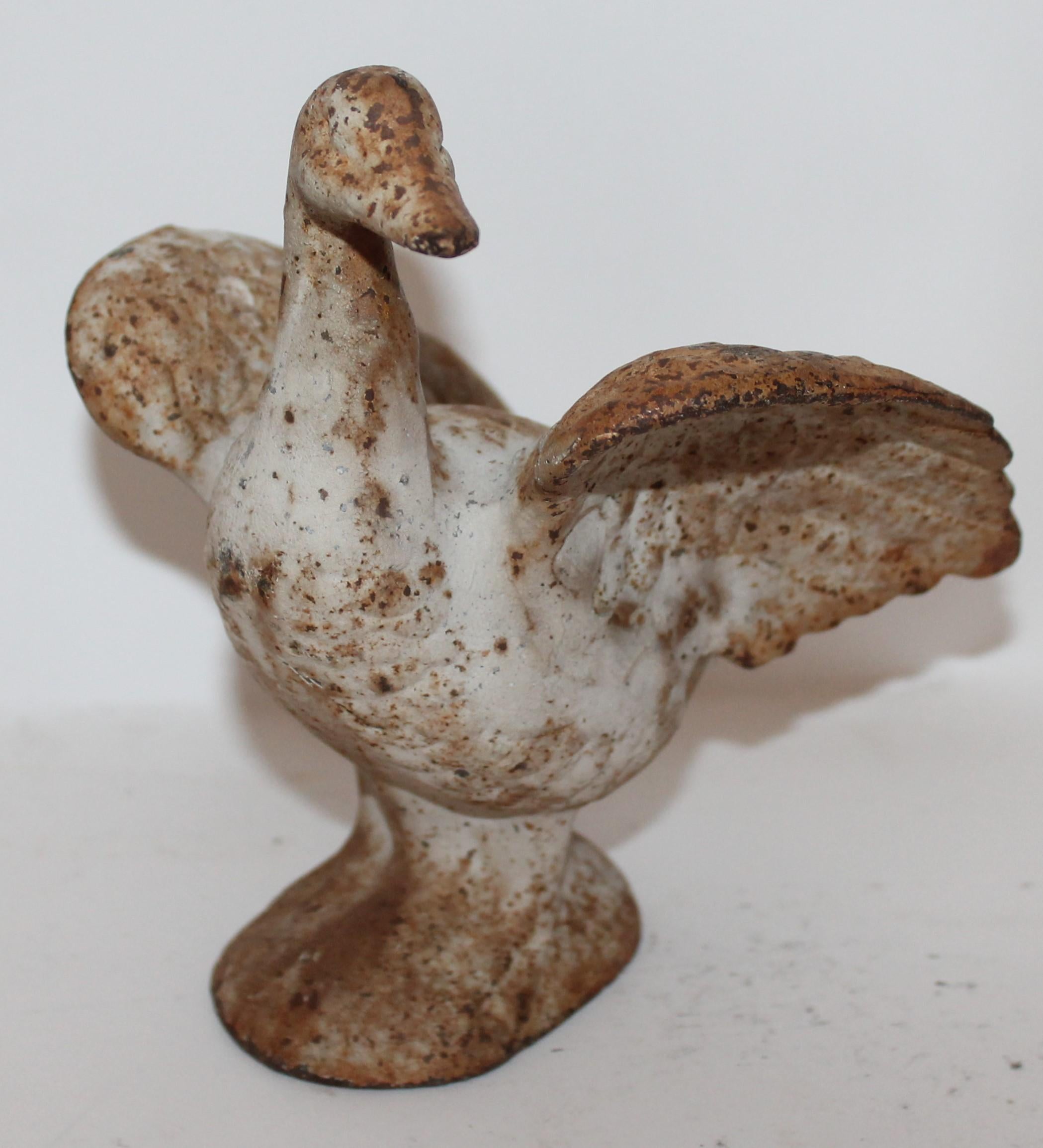 This original white painted cast iron dove is either a door stop or garden ornament. The condition is good with oxidation and patina.