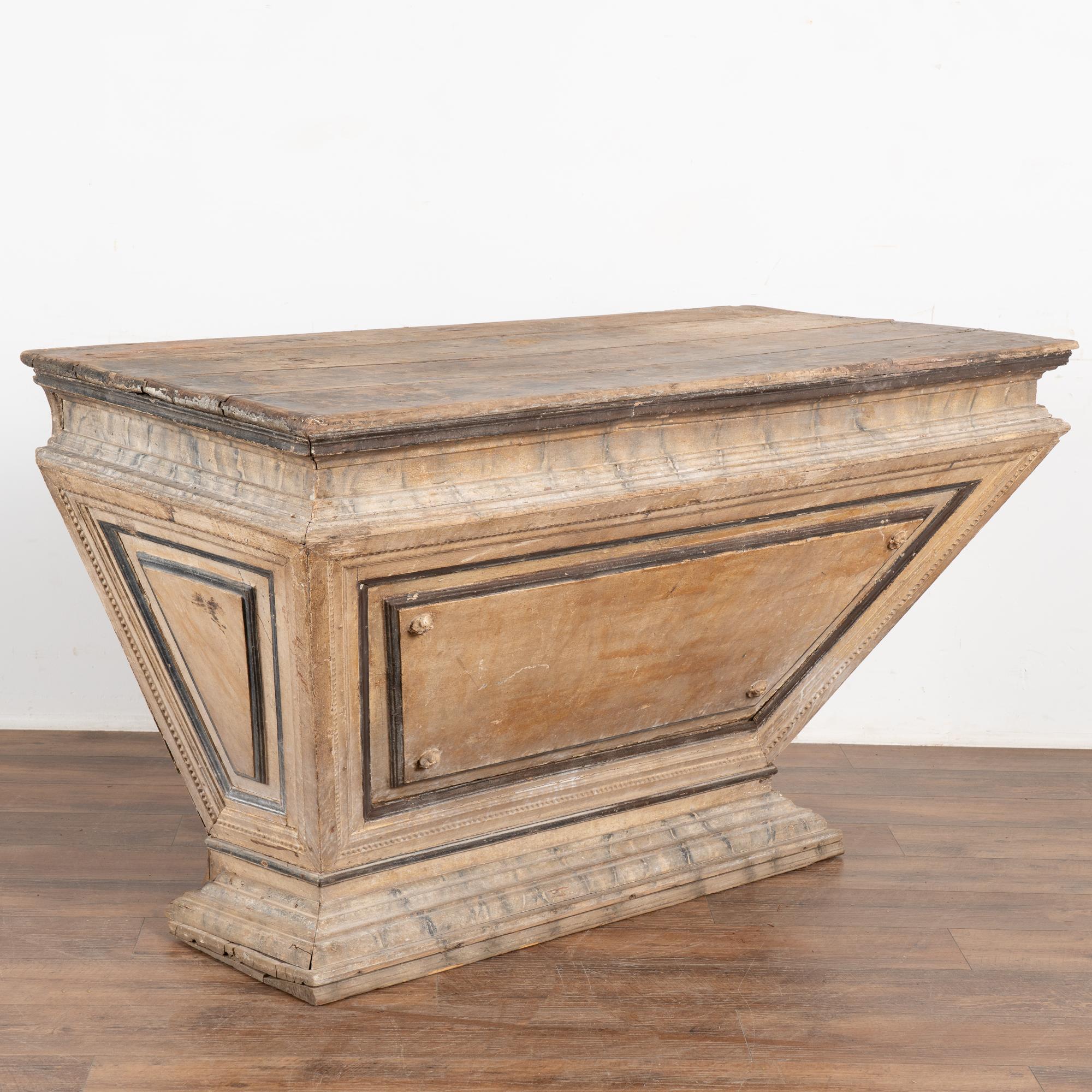 This impressive console will make a grand statement in any home. The uniquely shaped wood base was hand-painted; one can still see the faux marble design that was a traditional style element of the era.  The original paint has faded and been