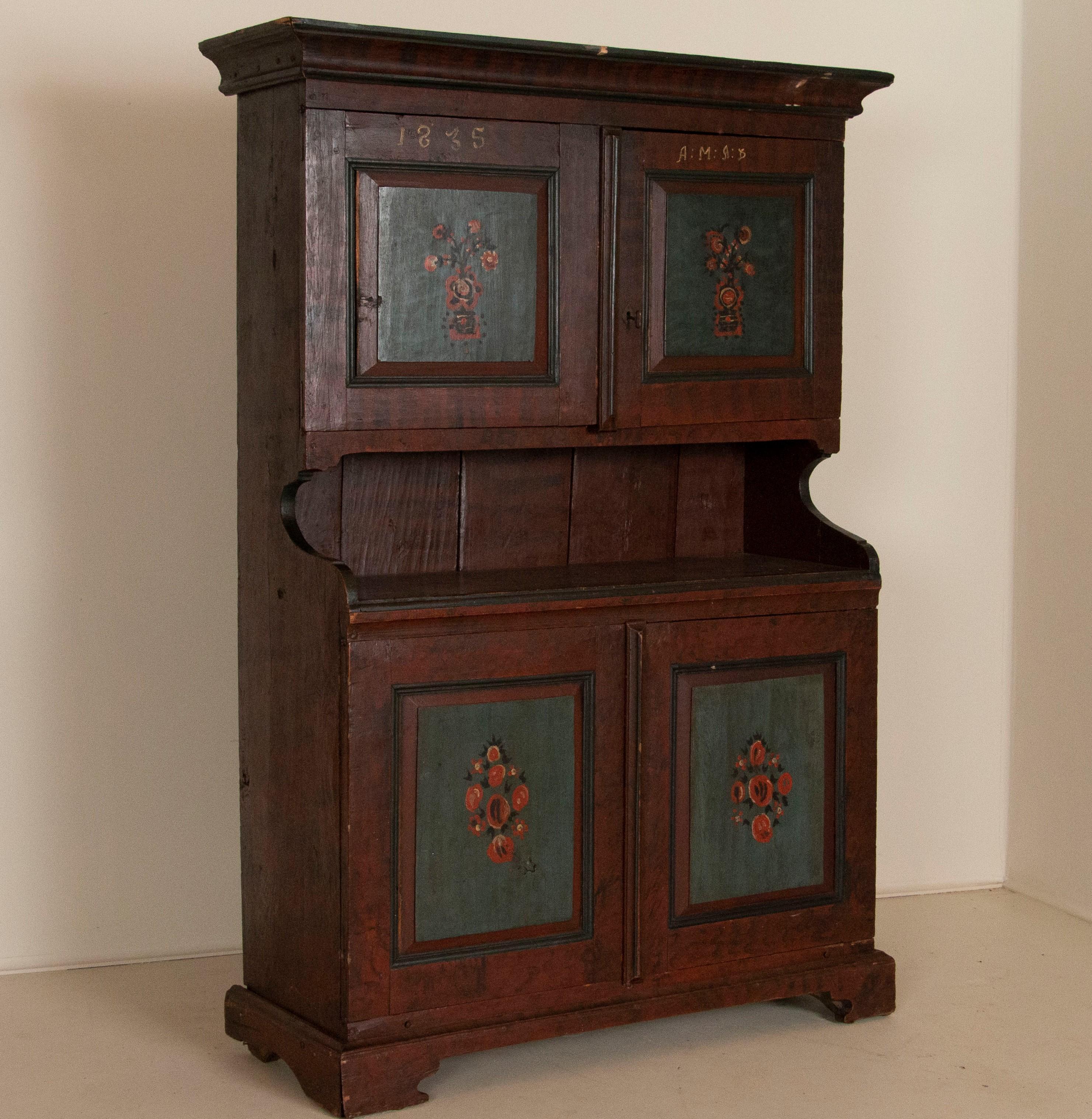 The paint and finish on this wonderful cupboard dated 1835 is all original, revealing its Swedish country roots. Everything about this painted cabinet hold to the traditional styles found in Sweden in the 1800s. The 4 paneled doors all have a teal