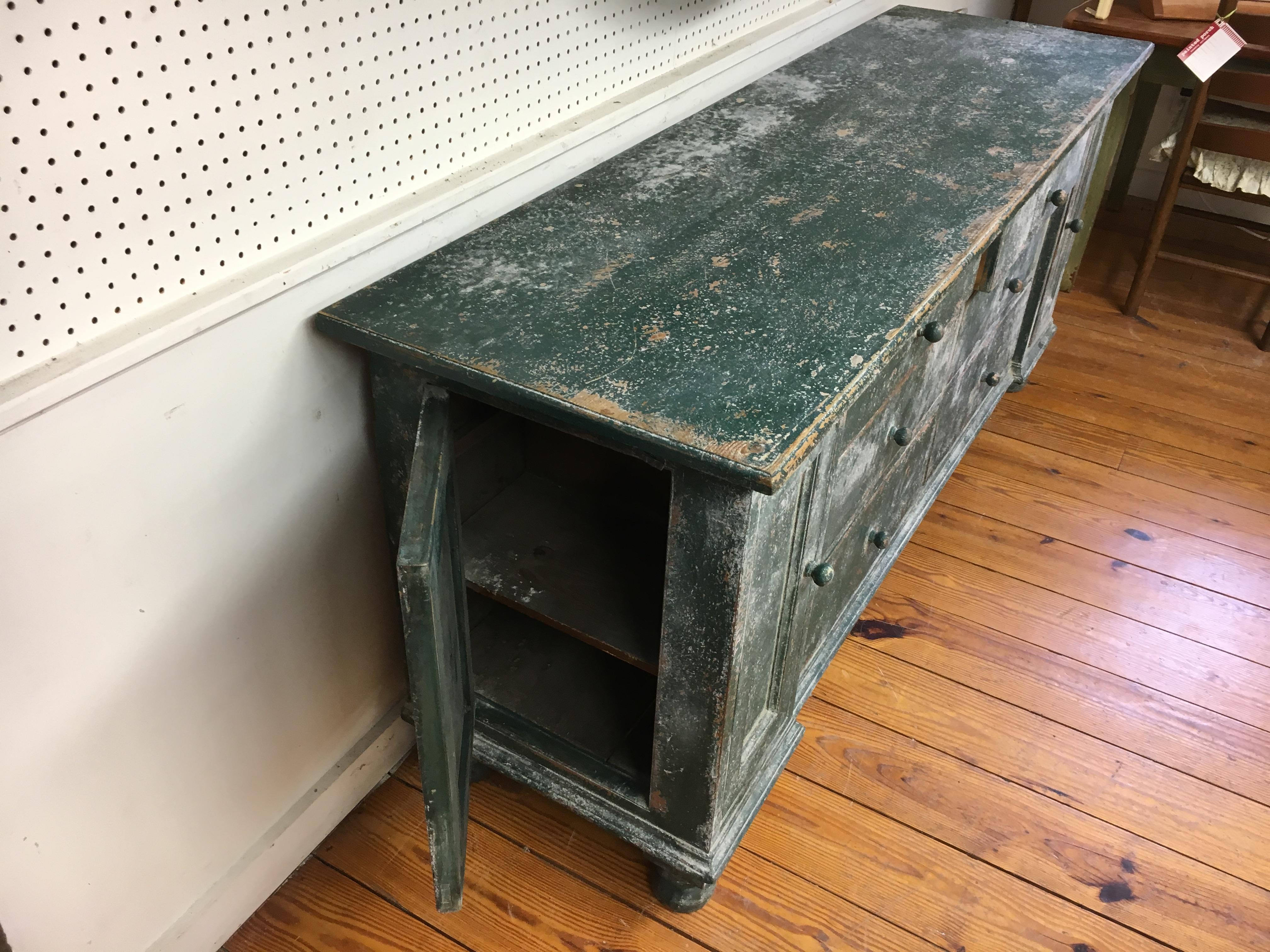 I will never find a dresser base any nicer than this piece. Original green paint, with drawers and doors galore. Six drawers and two doors in front and on the left side is a small door at the end of this gorgeous piece. It is totally original and