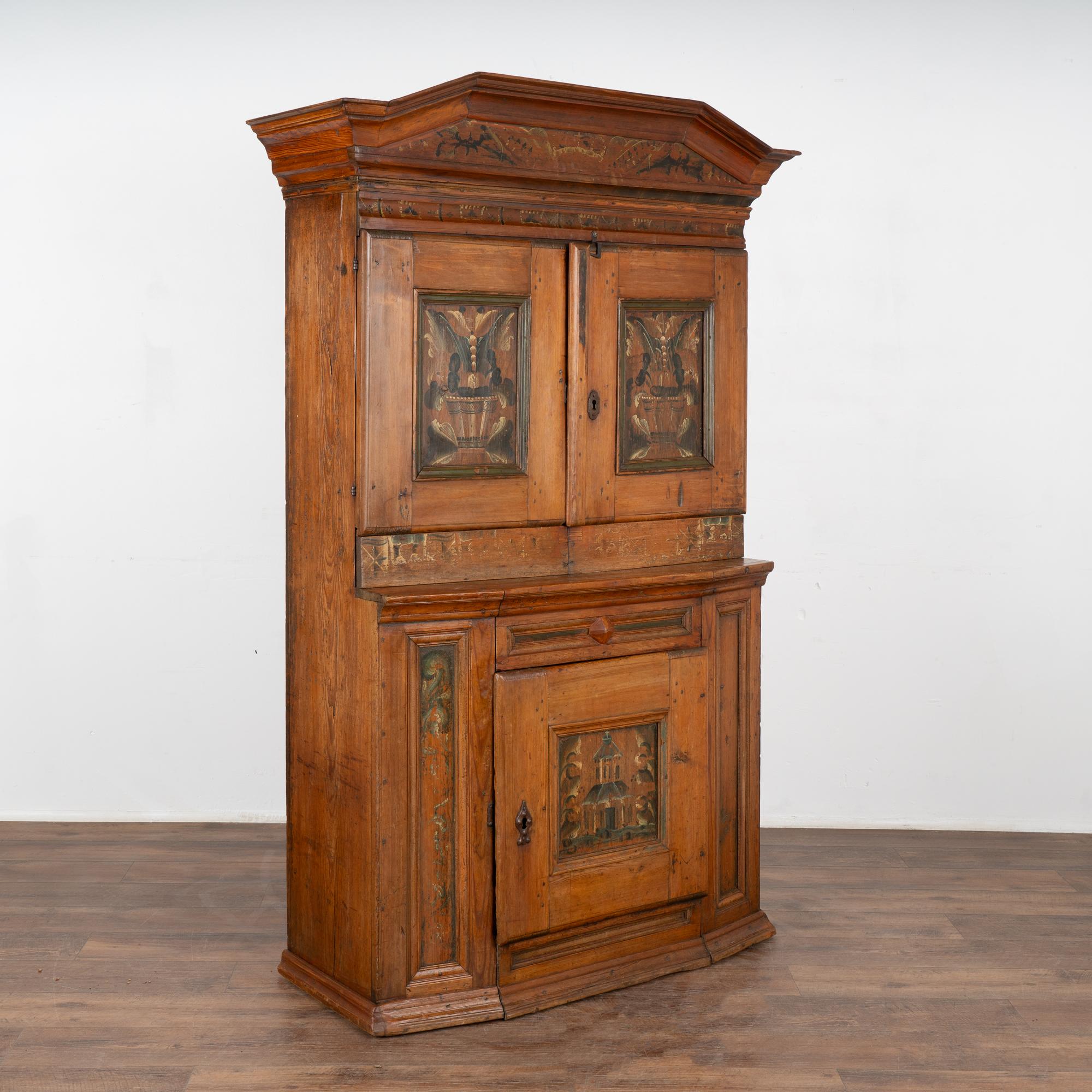 This pine cabinet is a remarkable example of Swedish country craftsmanship and original folk art painting. The deep patina of the pine is a result of many generations of use and age.
The door panels and crown are embellished with hand painted