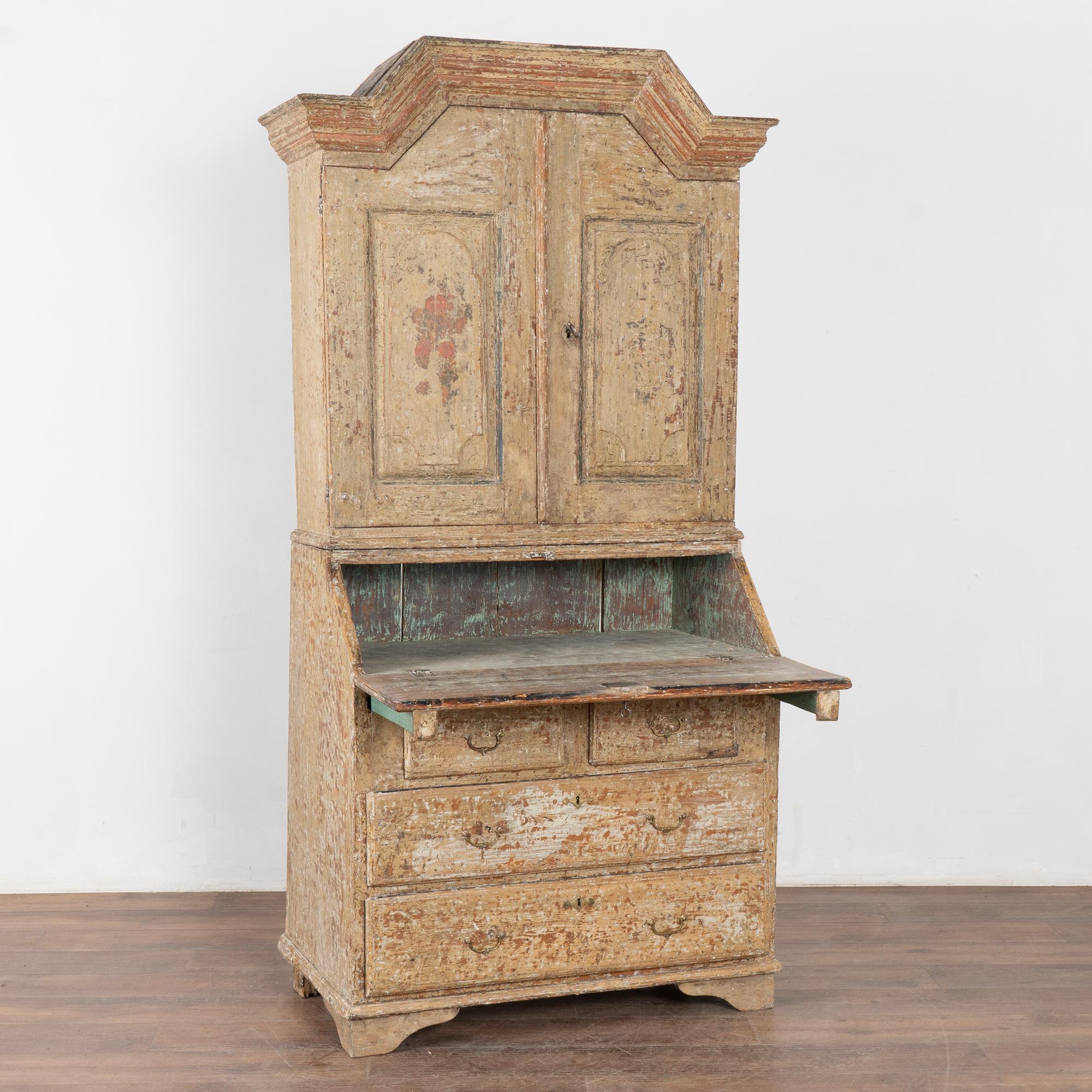 Pine secretary crafted in  the early 1800's in Sweden. Note the original gray painted finish (with green undertones) with red and blue accents as well. 
The original painted finish has been worn and scraped to reveal layers of colors including