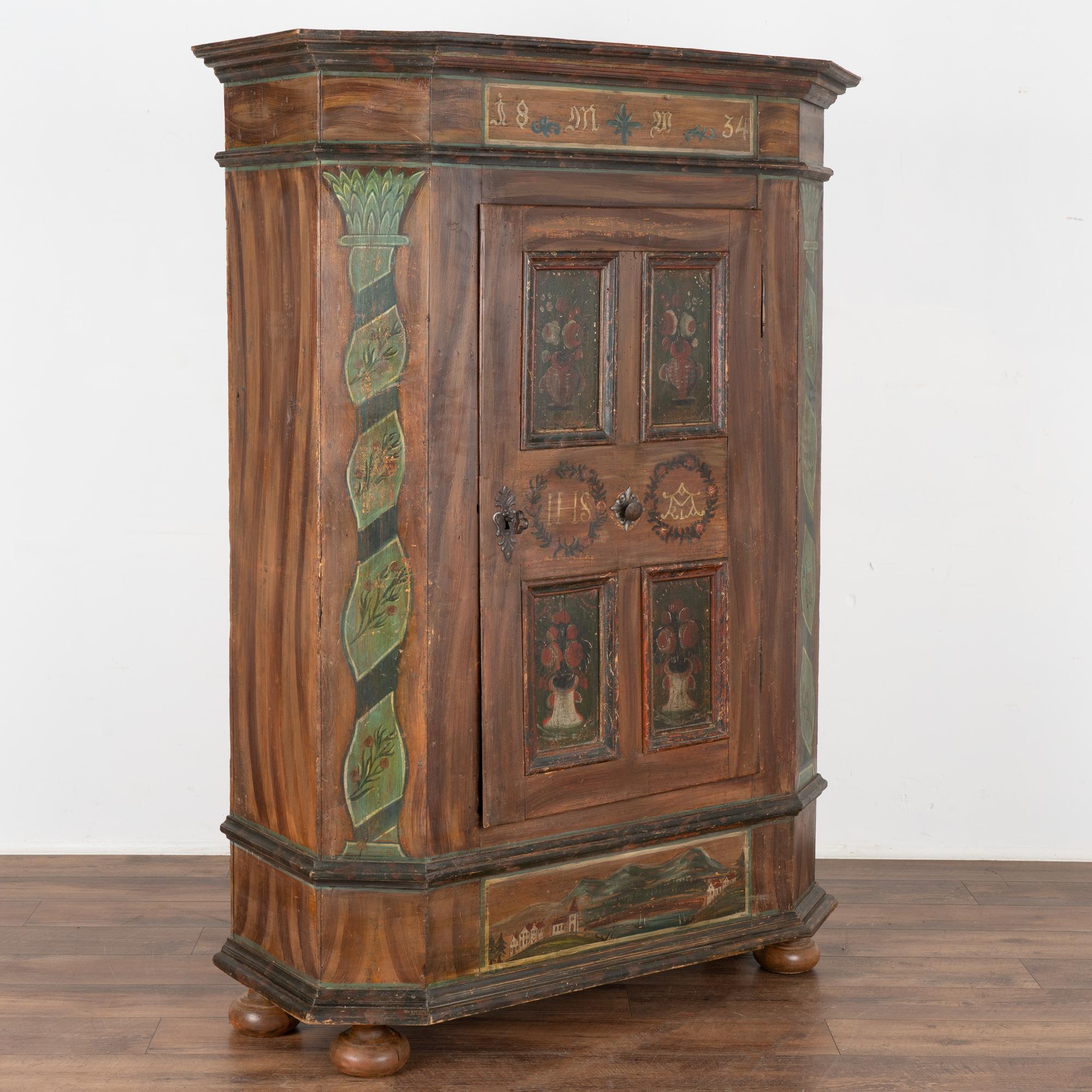 This lovely painted armoire still maintains the quality and details of the original hand-painted finish. The soft, gentle colors with delightful floral motifs are beautifully executed.
Notice the four panels of flowers in the door against a