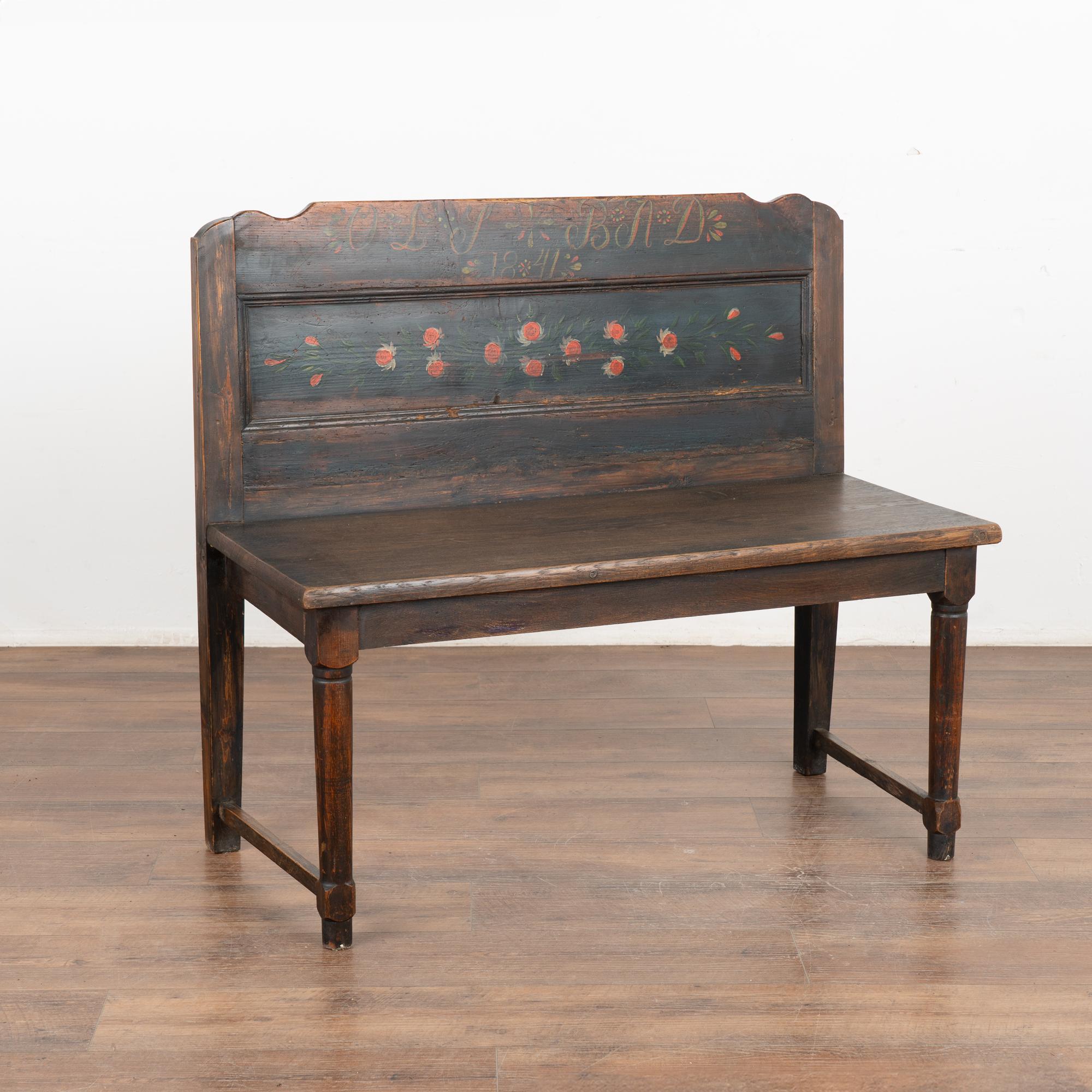 This delightful bench is a fun find due to its unique smaller scale at just over 3' long, perfect for a small space.
Original hand painted details include red flowers, date of 1841 against blue painted background of tall back. Seat and legs appear