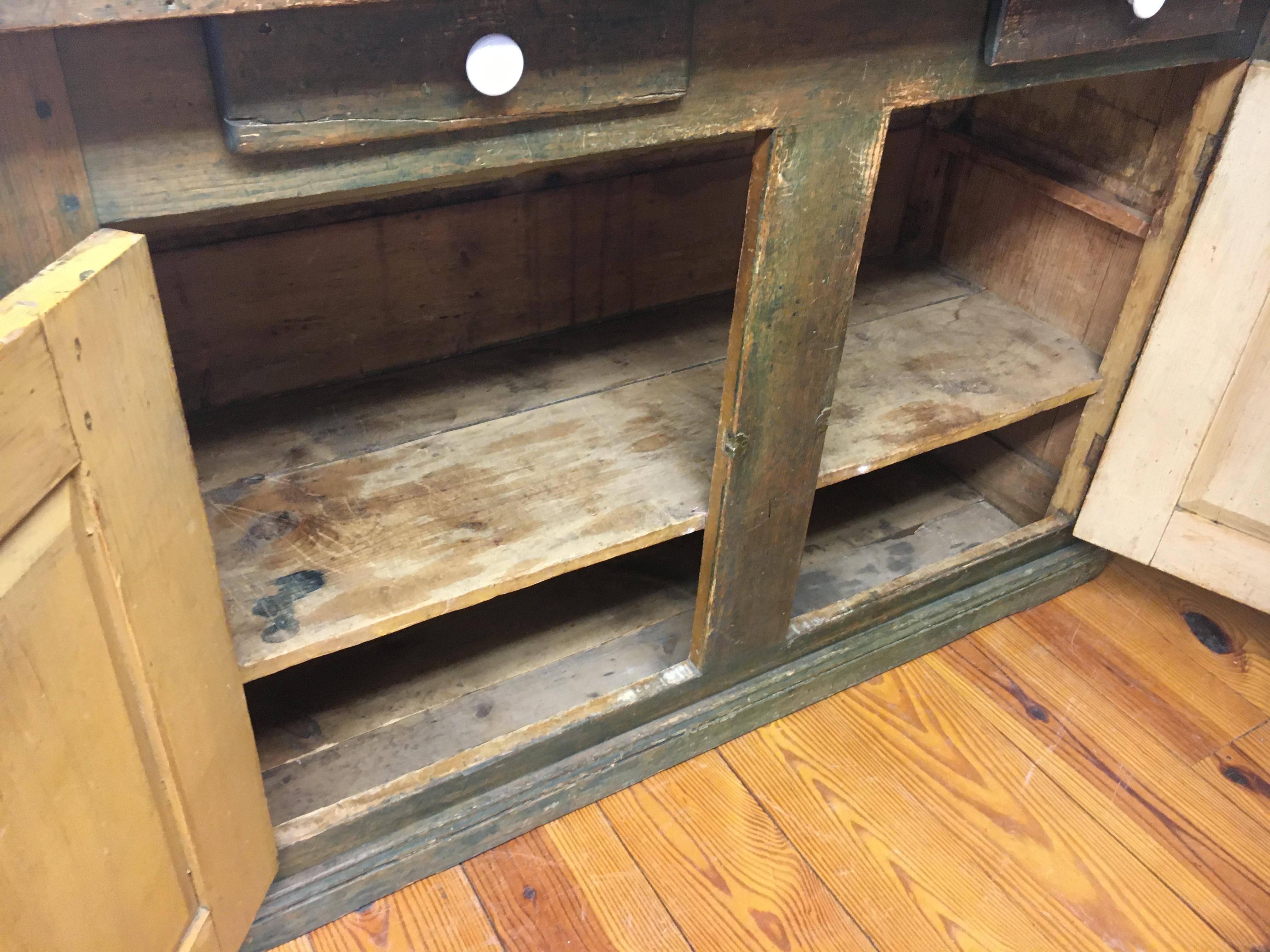 This two door, two drawer soft green buffet has porcelain hardware and shelves inside. the moss green color is special like almost all Canadian painted pieces. This would work in any room in your home.