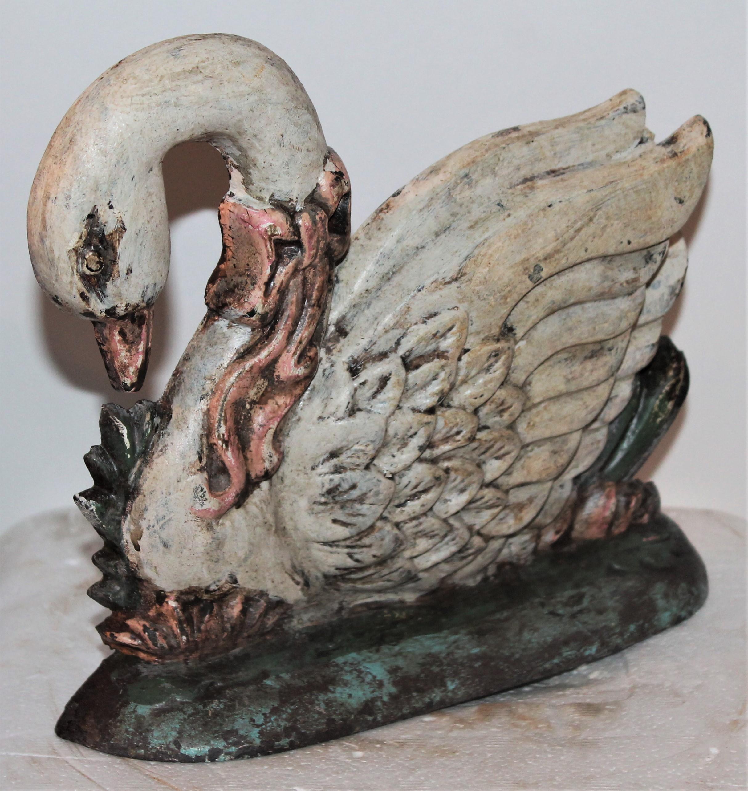 This early 20th century original painted cast iron swan door stop. This has a old worn patina but is all original surface.