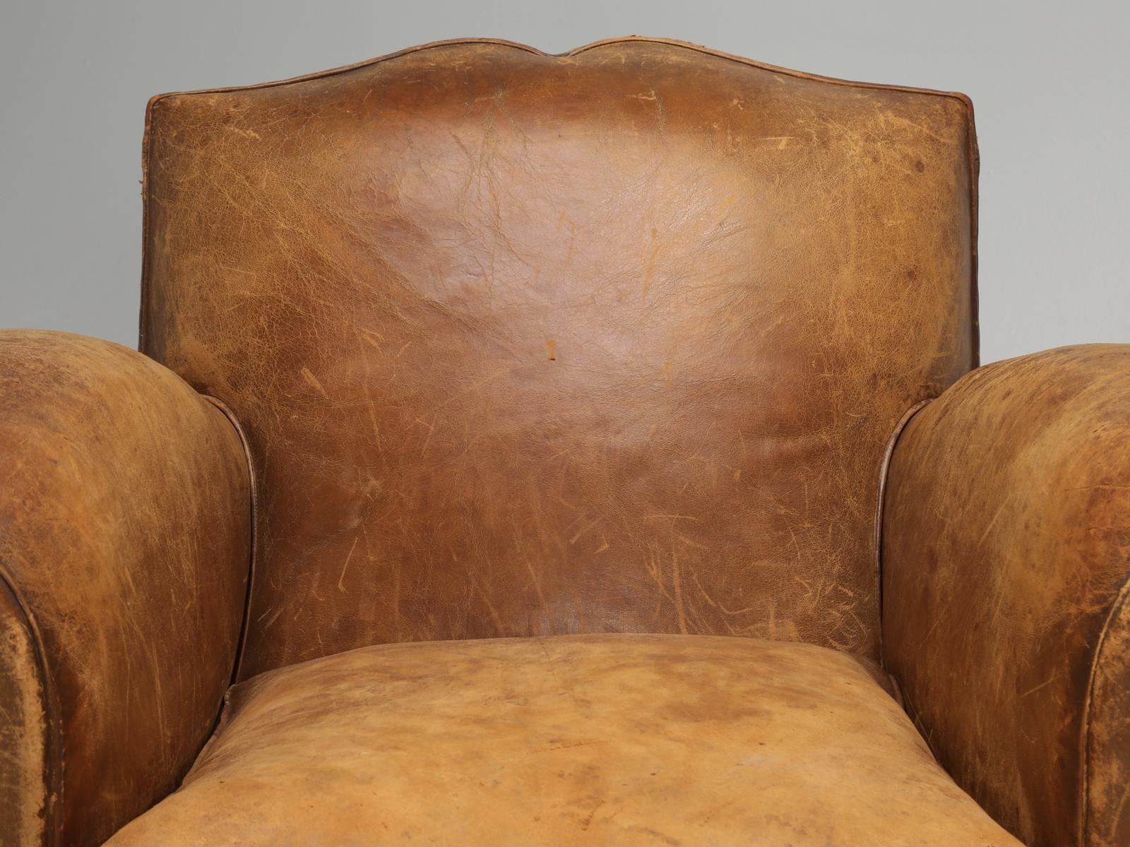 A completely original pair of French leather Art Deco club chairs, that have the appearance that they have not been touched in over 85-years. However, the truth is, that each French club chair was painstakingly disassembled and rebuilt from the