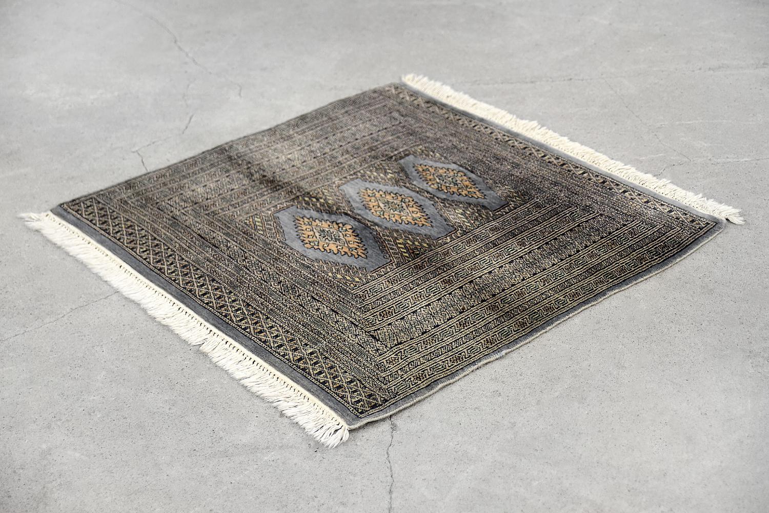 This hand knotted oriental rug was made in Pakistan in the 1960s. Traditionally flat woven and dyed in shades of blue and gray. It was woven with natural wool and cashmere. Due to the appropriate treatment and polishing, the wool obtains a beautiful