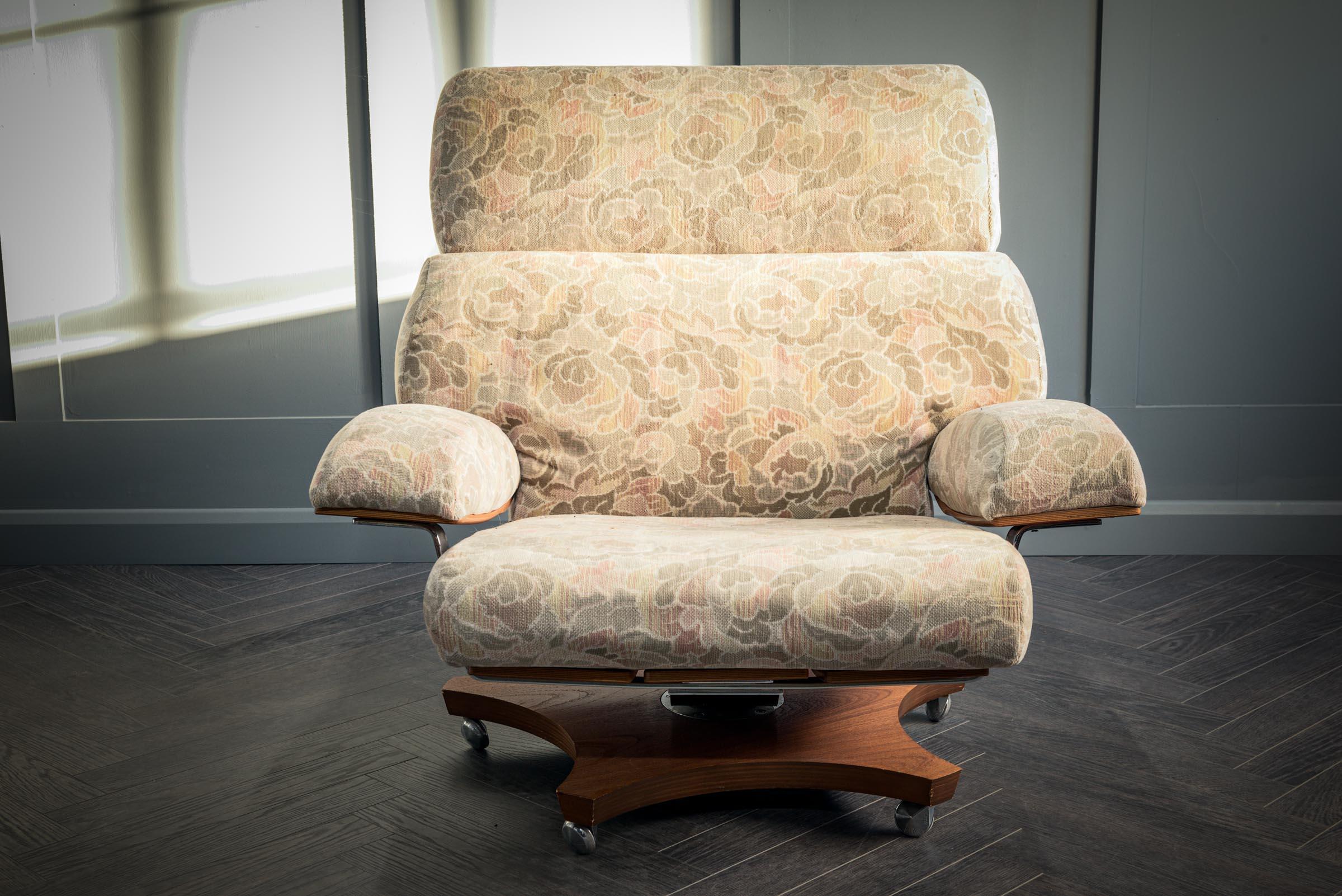 An absolutely stunning English mid-century Housemaster swivel chair in teak with original patterned fabric and chrome. Circa 1970, this design classic was conceived by K M Wilkins for G plan. Sold exclusively through the likes of Harrods and Heals,
